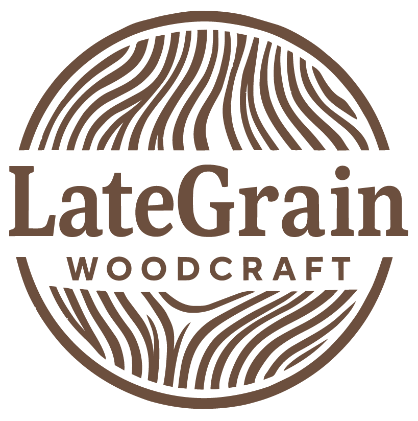 Logo for LateGrain Woodcraft featuring a stylized circular woodgrain pattern and text.