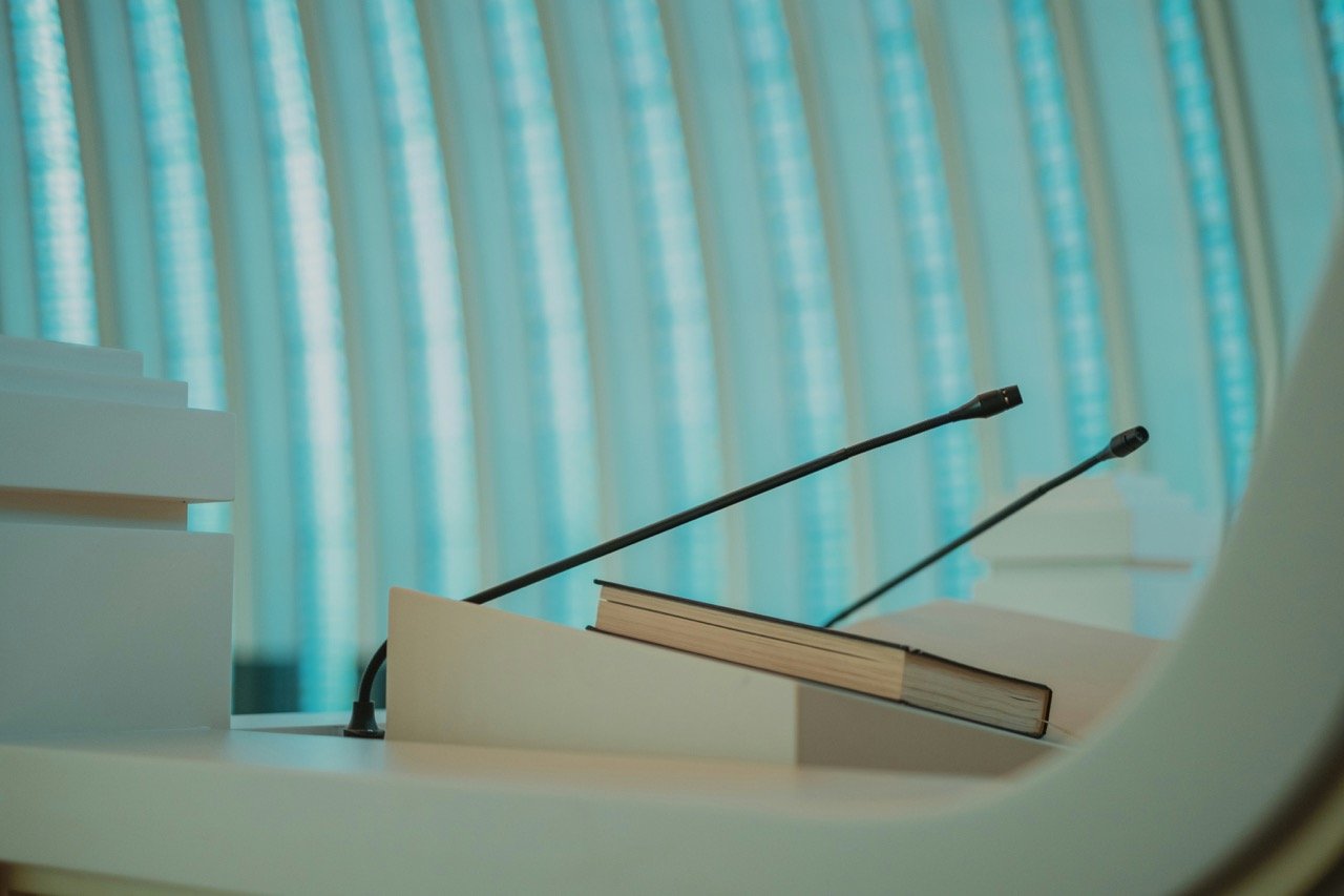 A podium with a microphone and a book on it.