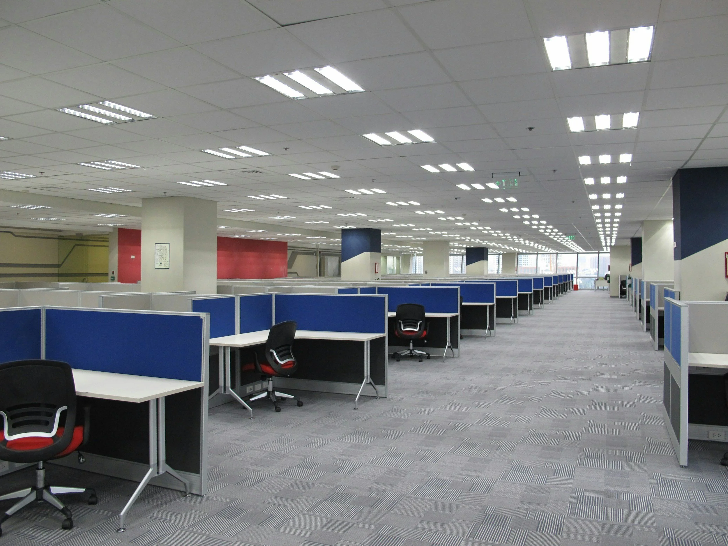 Empty Office Cubicles with Black and Red Chairs