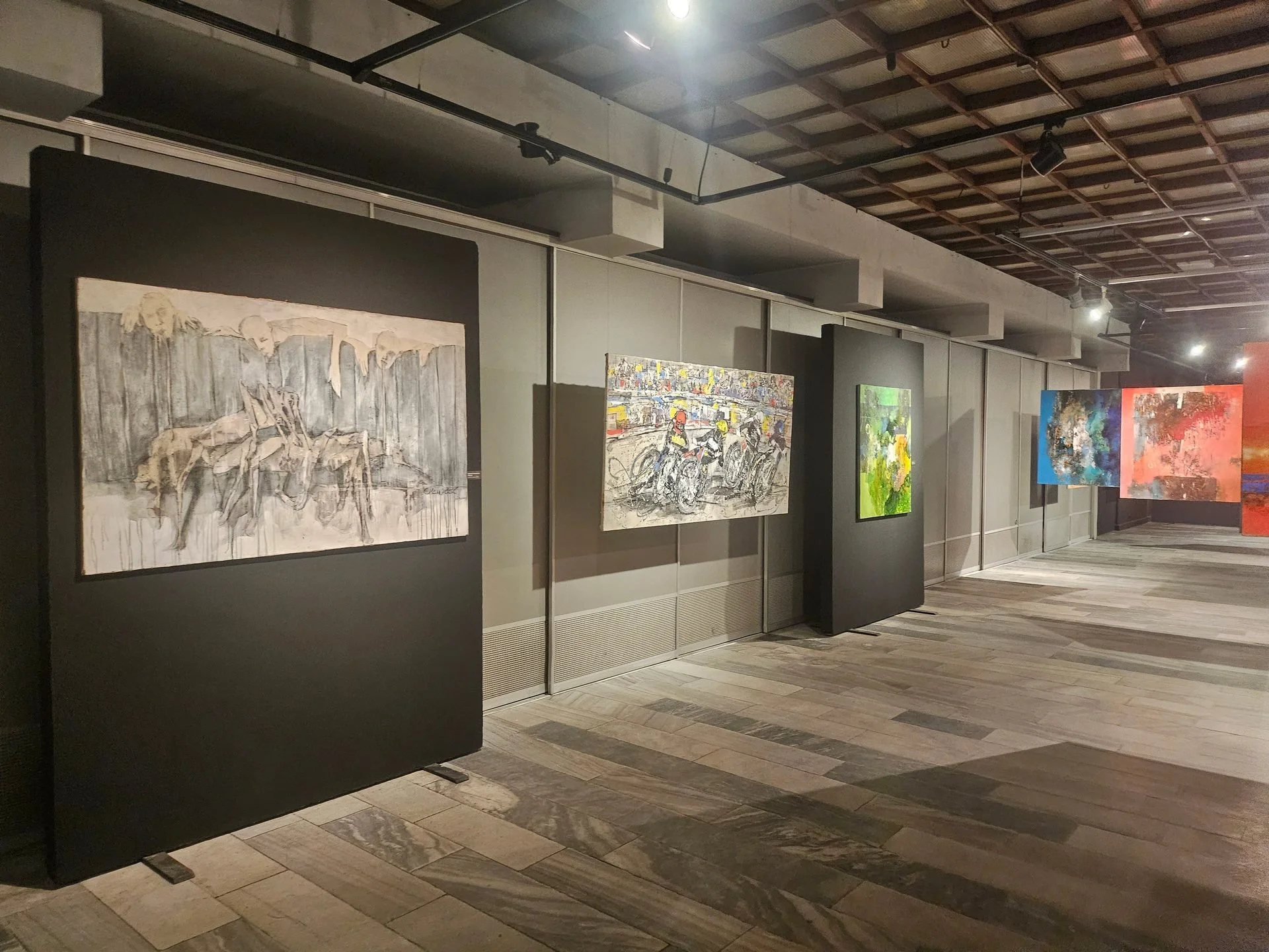 Abstract contemporary paintings featuring expressive forms, layered textures and dynamic composition displayed in a gallery space