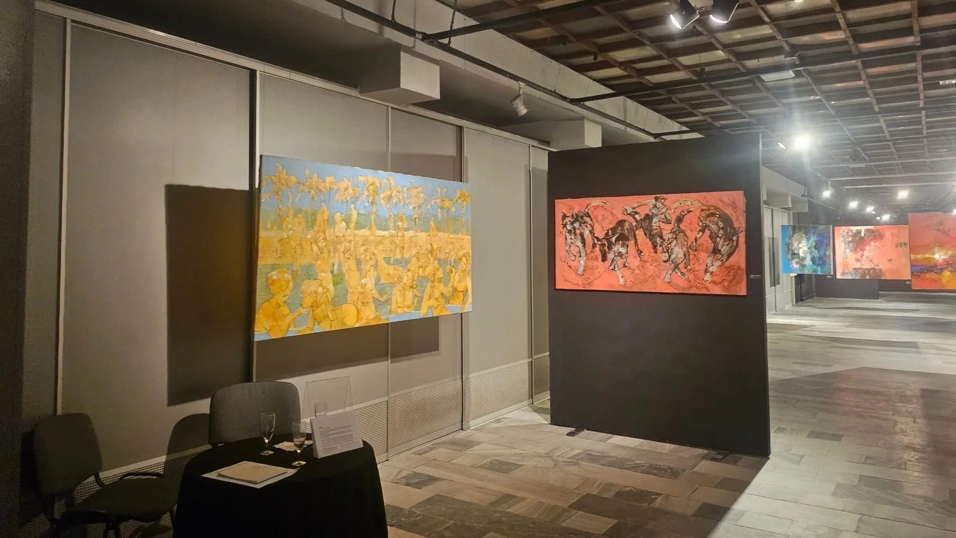 Art gallery exhibition featuring two figurative artworks with strong motion and expressive technique