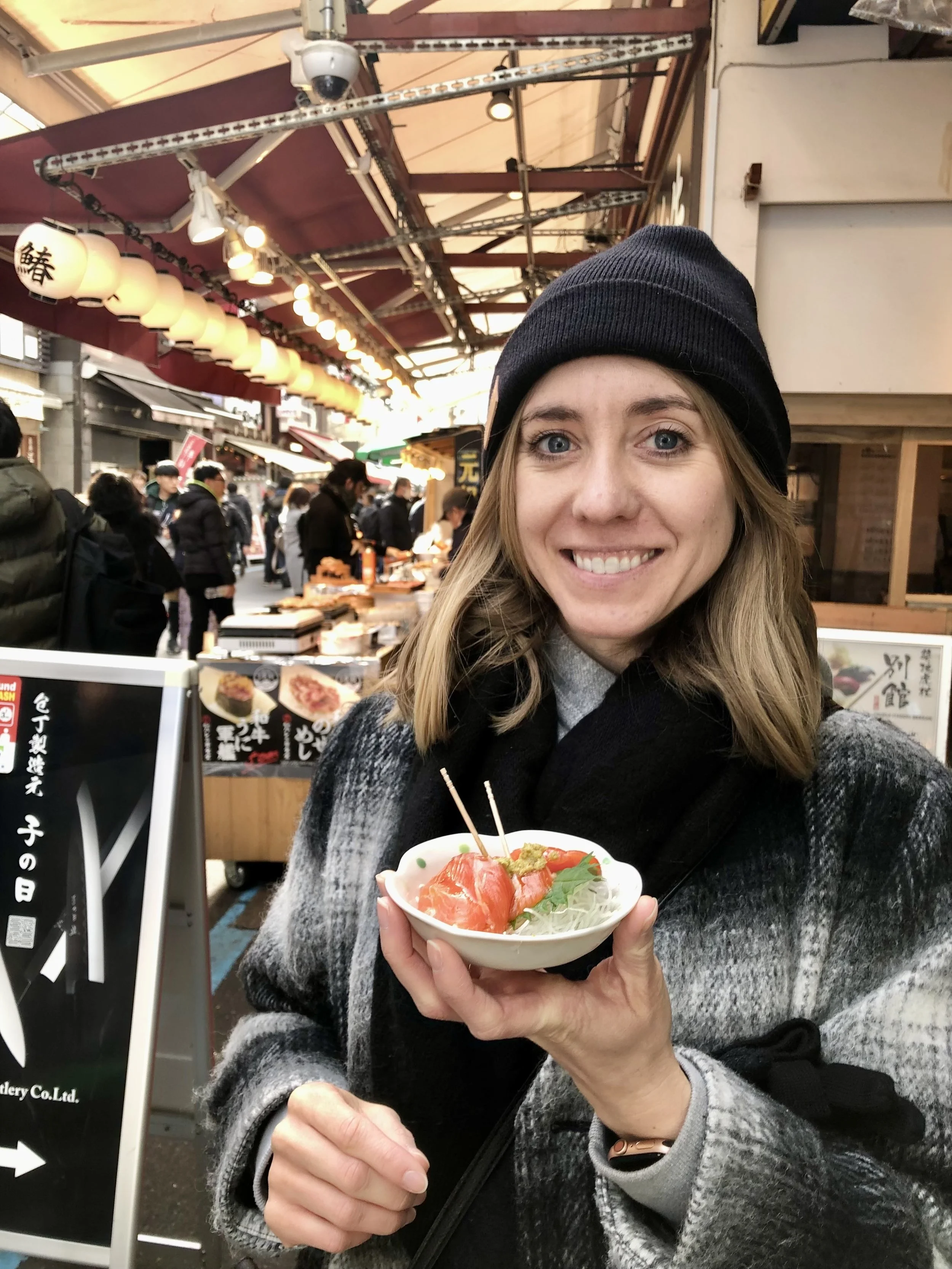 Cassie Broeckert in Japan eating a local dish from a street market