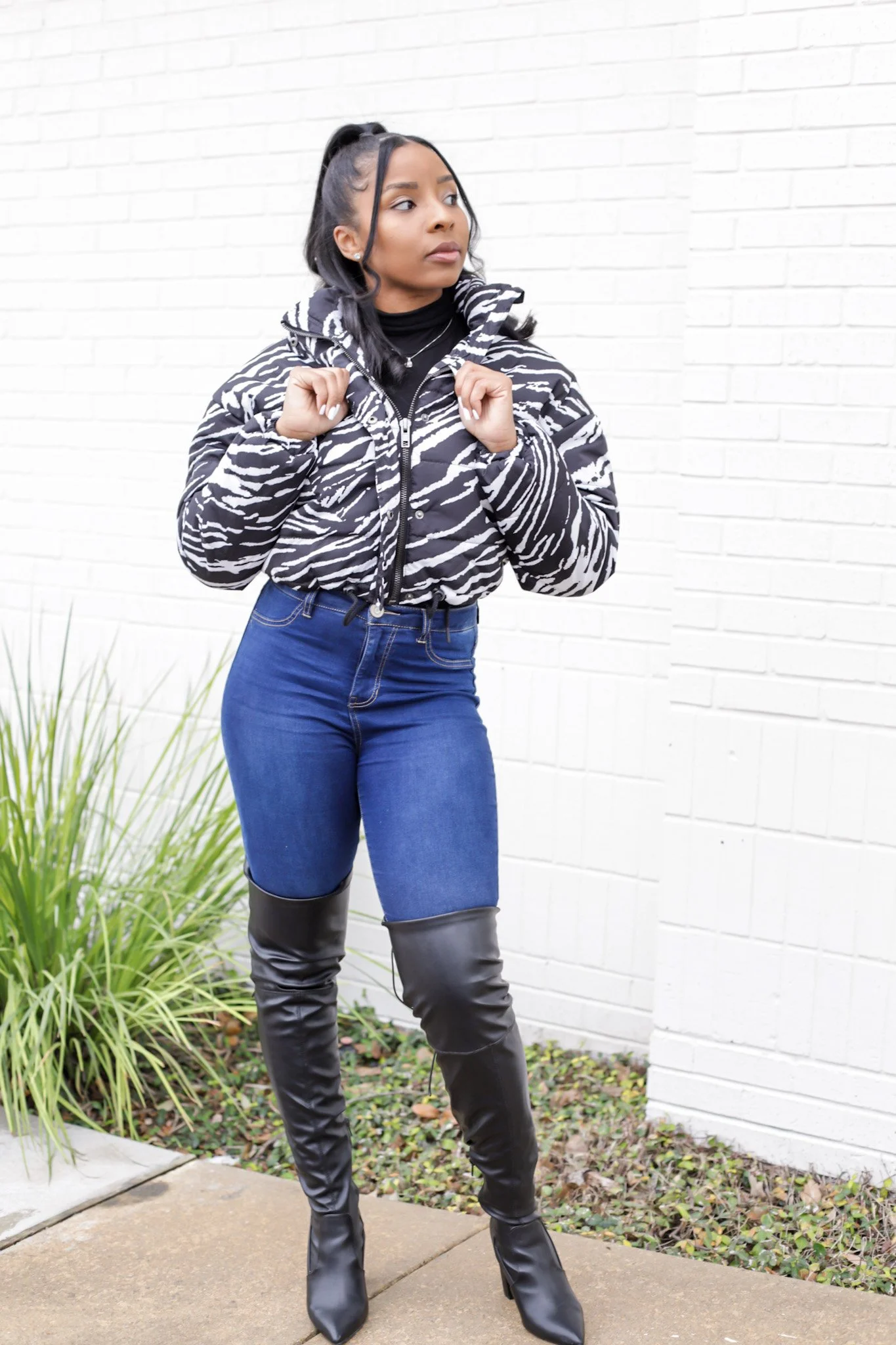 woman outside in zebra puffer jacket from fashion nova