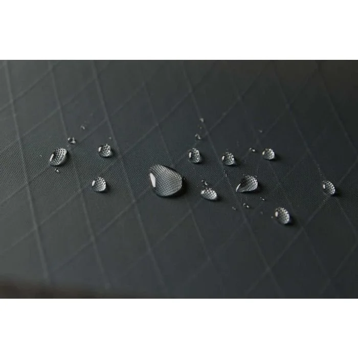 Water droplets on a black textured surface.