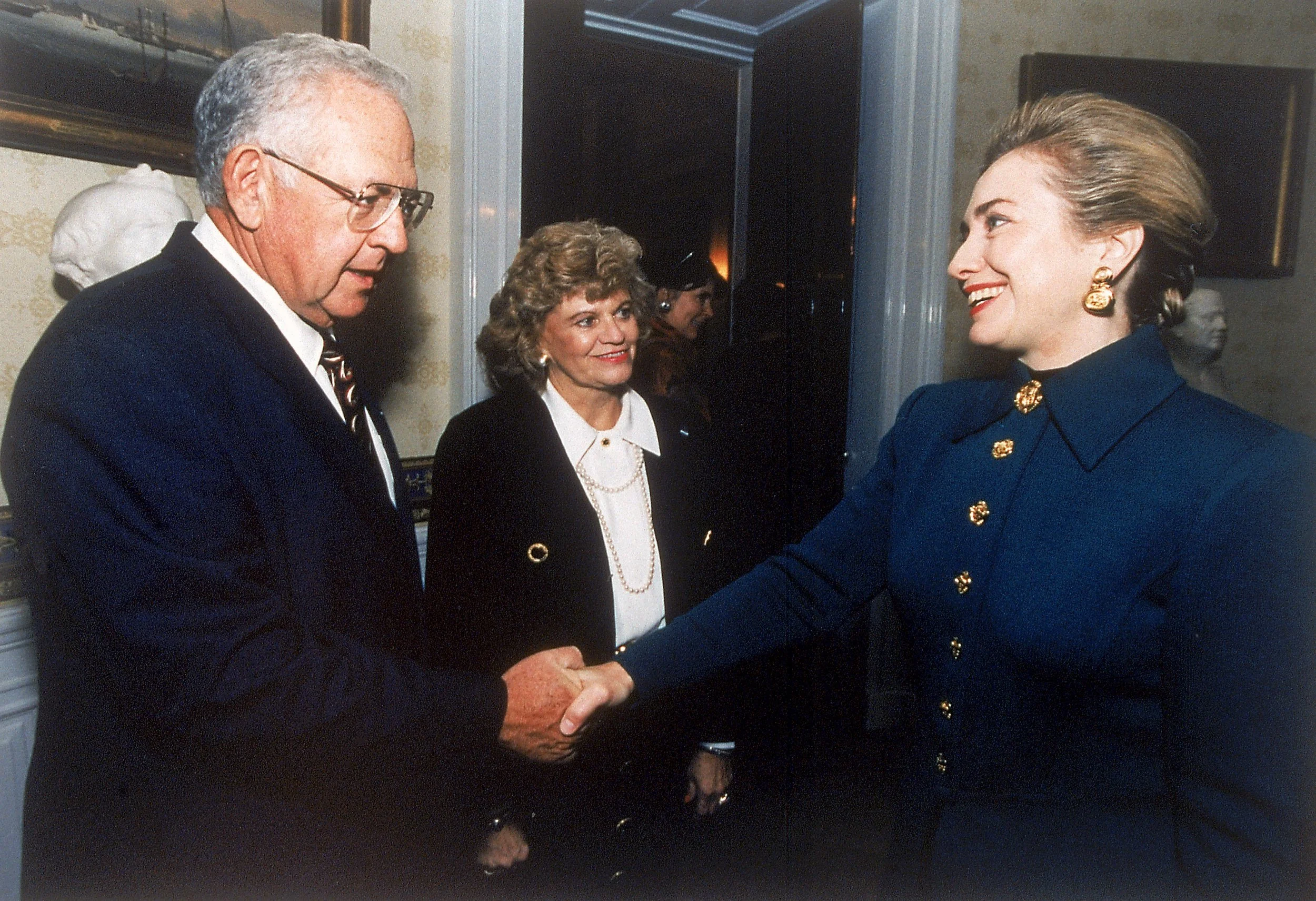 Dave Thomas, Founder of Wendy's, with his wife Lorainne, shaking hands with First Lady Hillary Clinton