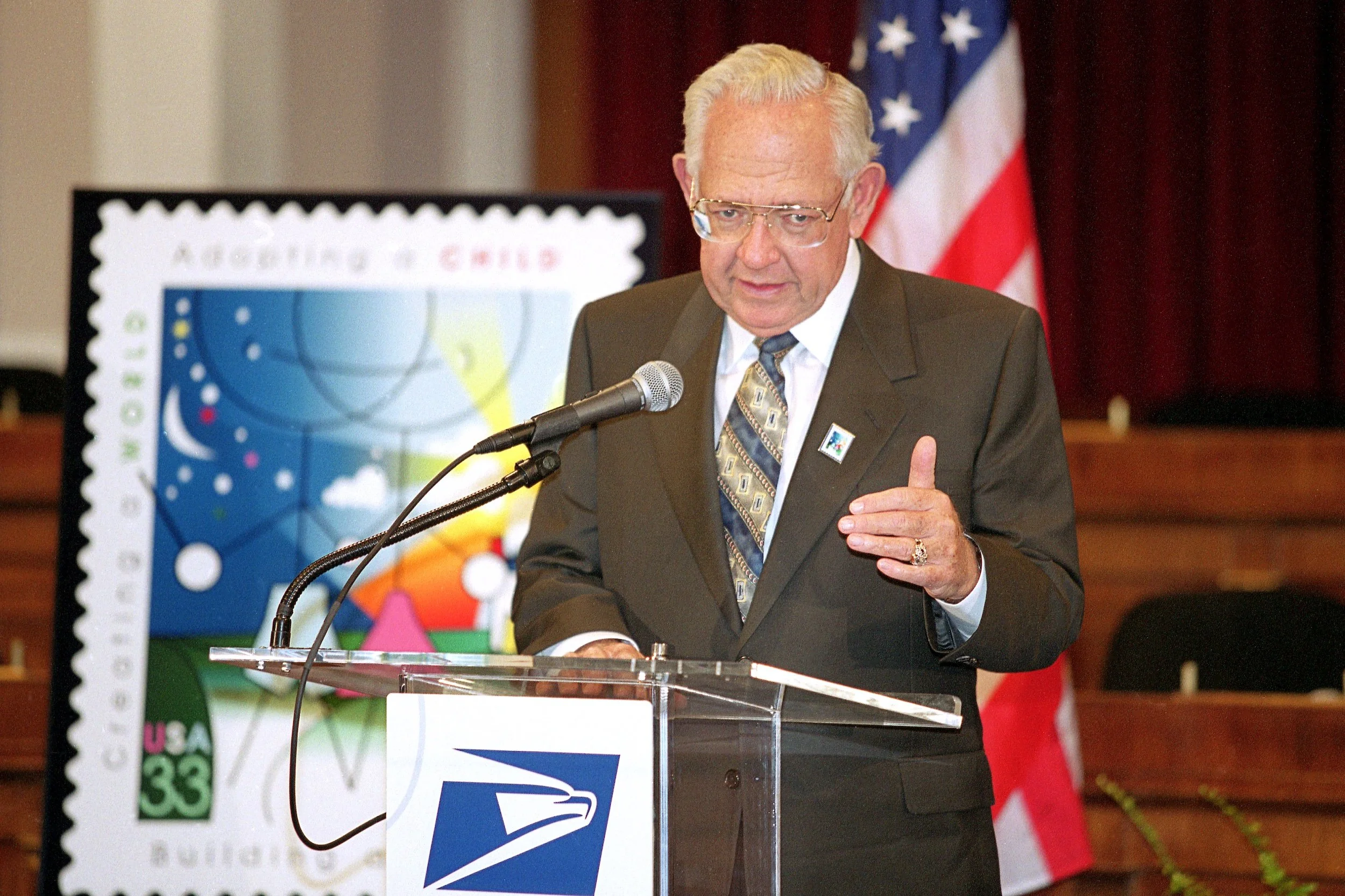 Dave Thomas with US Commemorative stamp celebrating adoption
