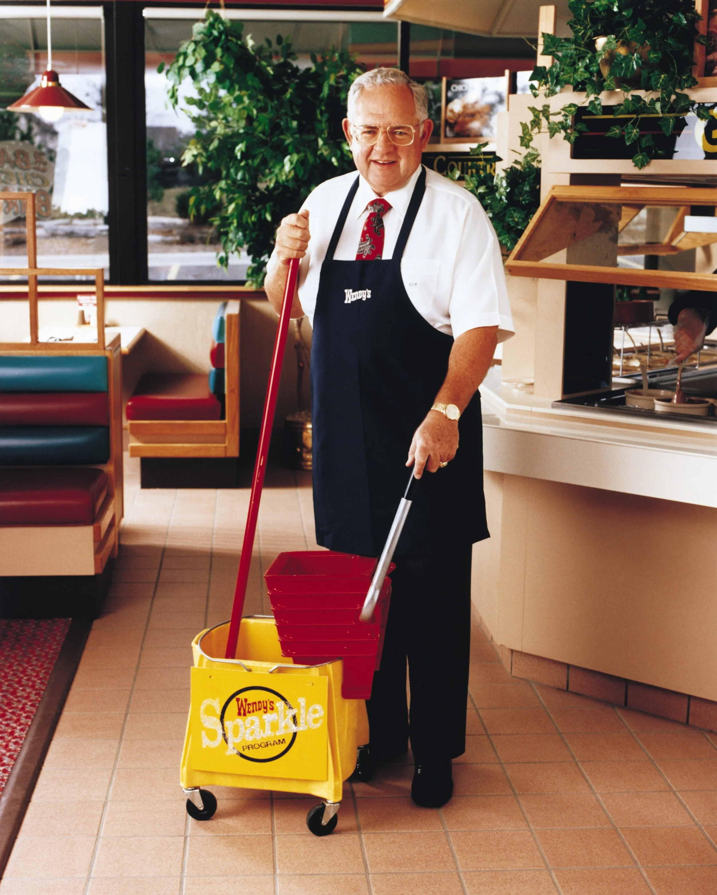 Dave Thomas at a Wendy's Restaurant with a mop bucket
