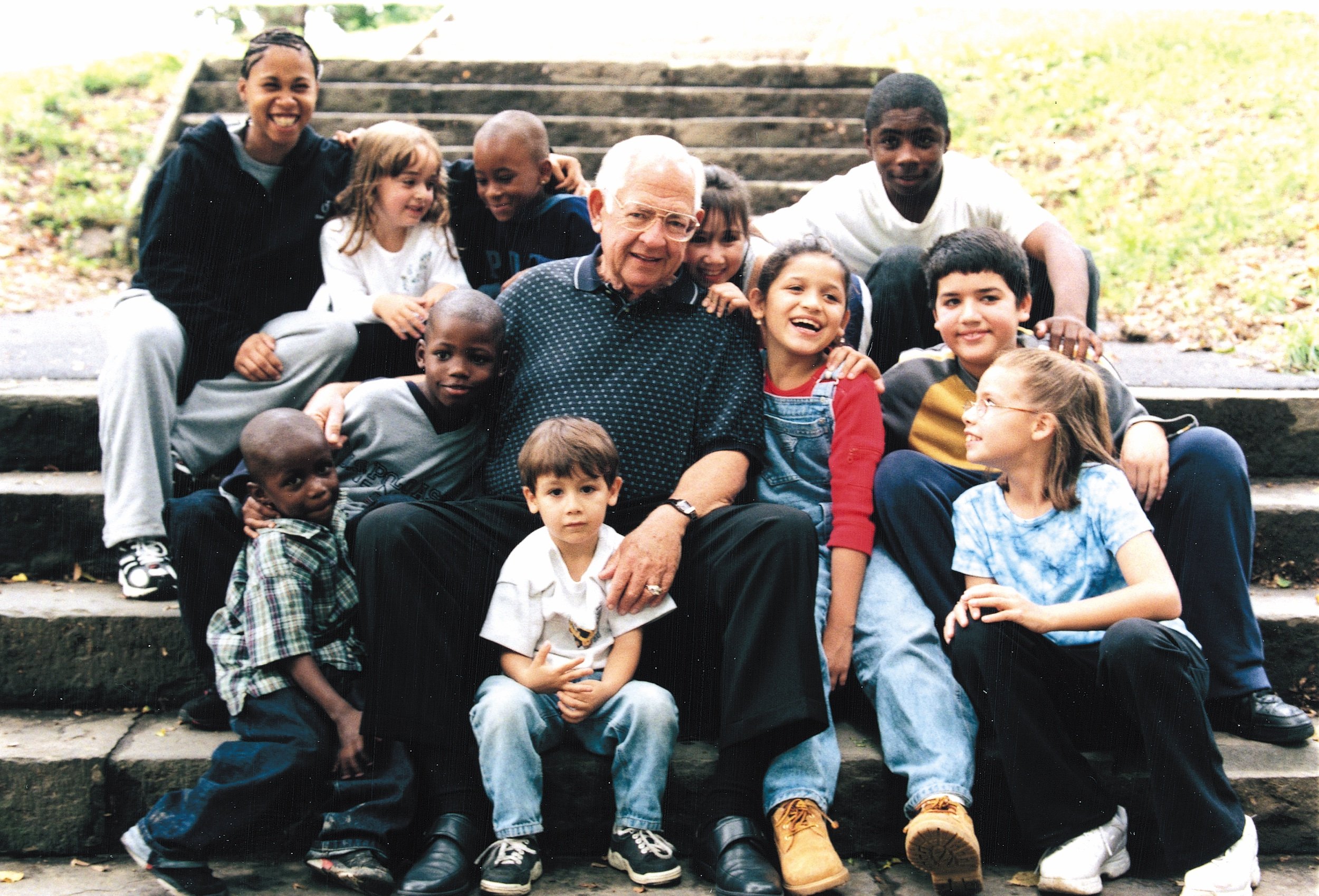 Dave Thomas, founder of Wendy's, posing with children in foster care