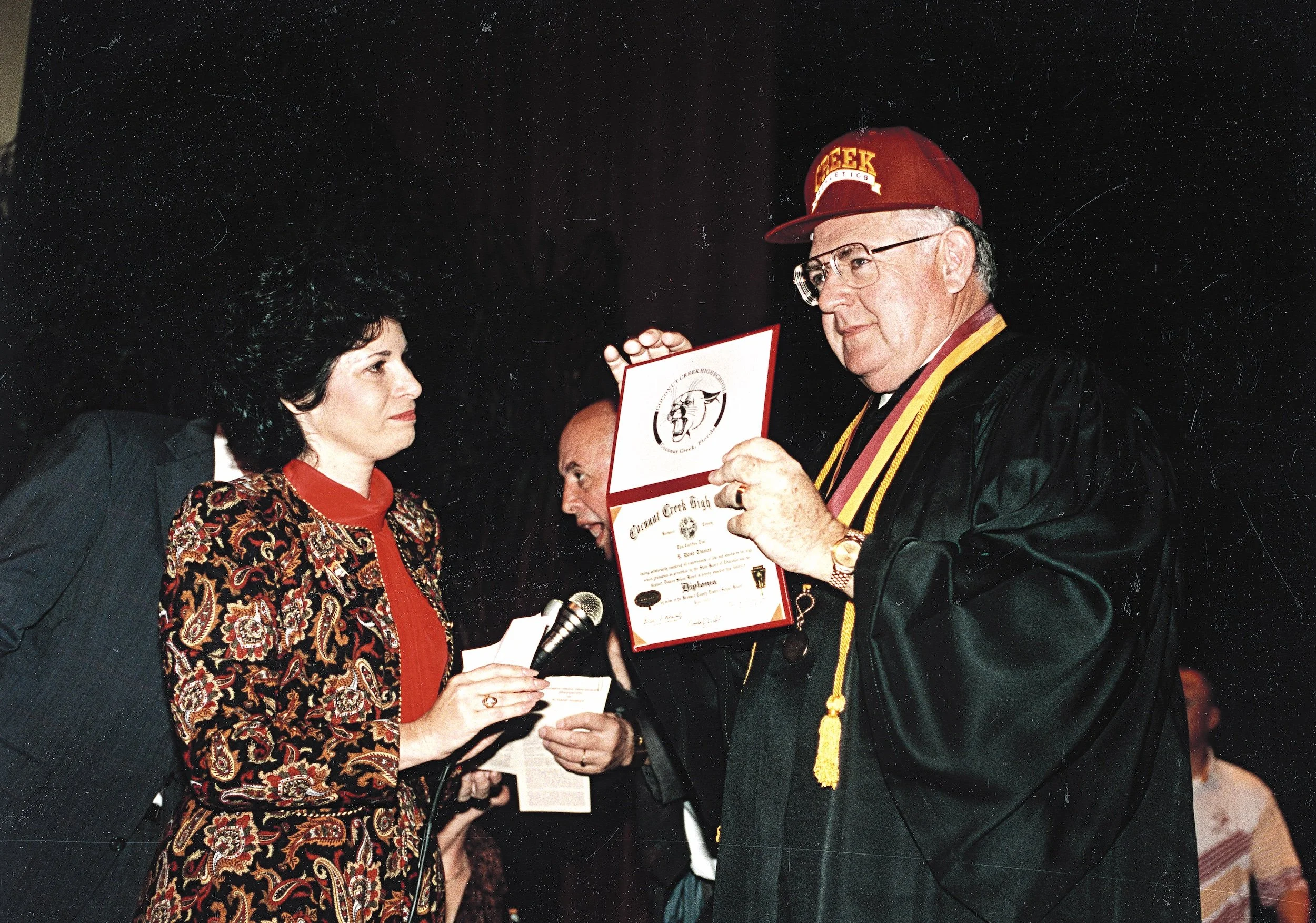 Dave Thomas, Founder of Wendy's, holding up his high school degree