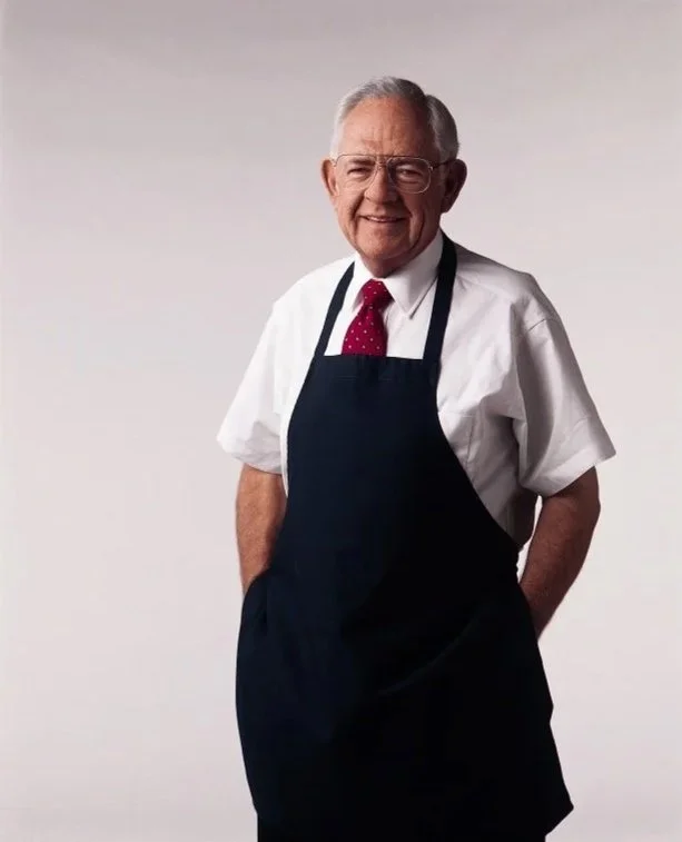 Dave Thomas wearing white shirt, red tie and blue apron