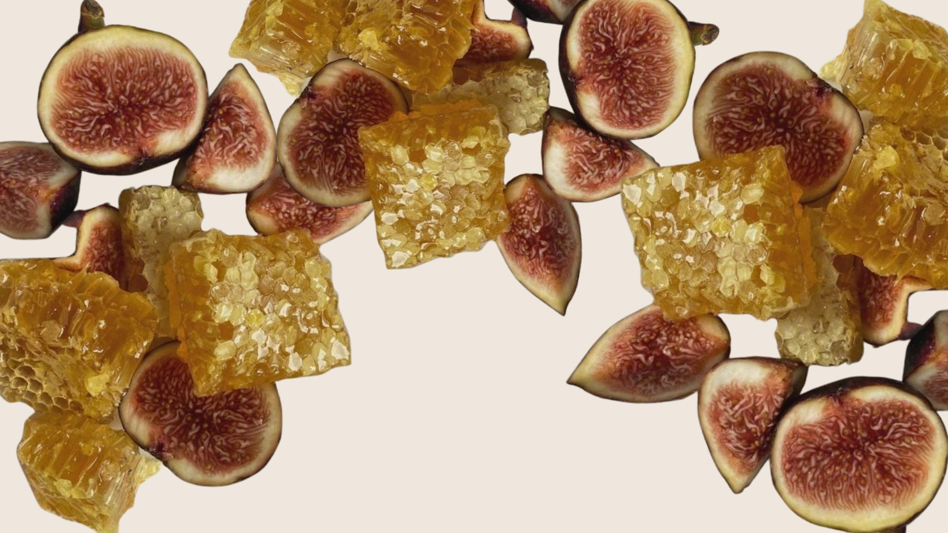 Figs and honeycomb pieces scattered on a white background.