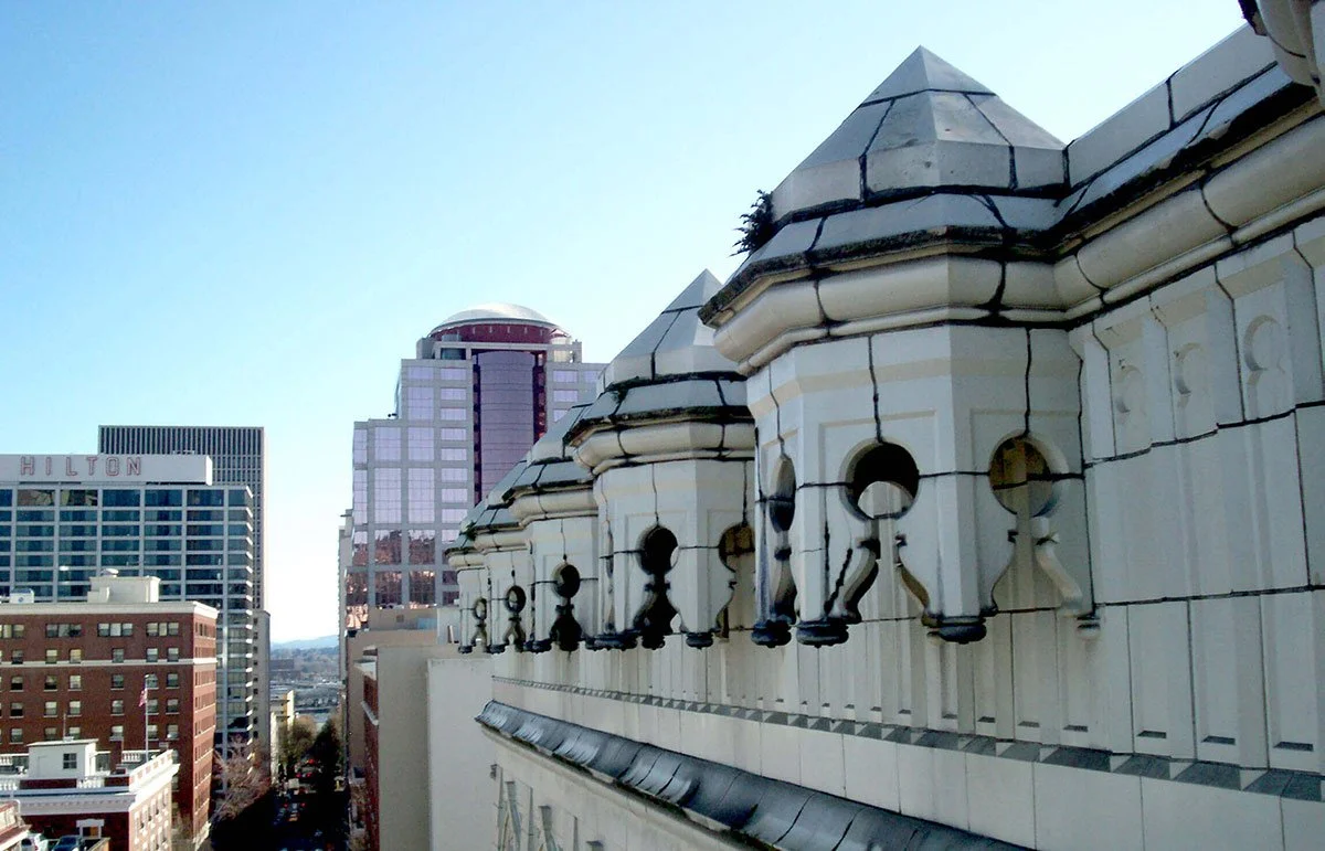 Cornice before restoration, note cracks and overgrowth.