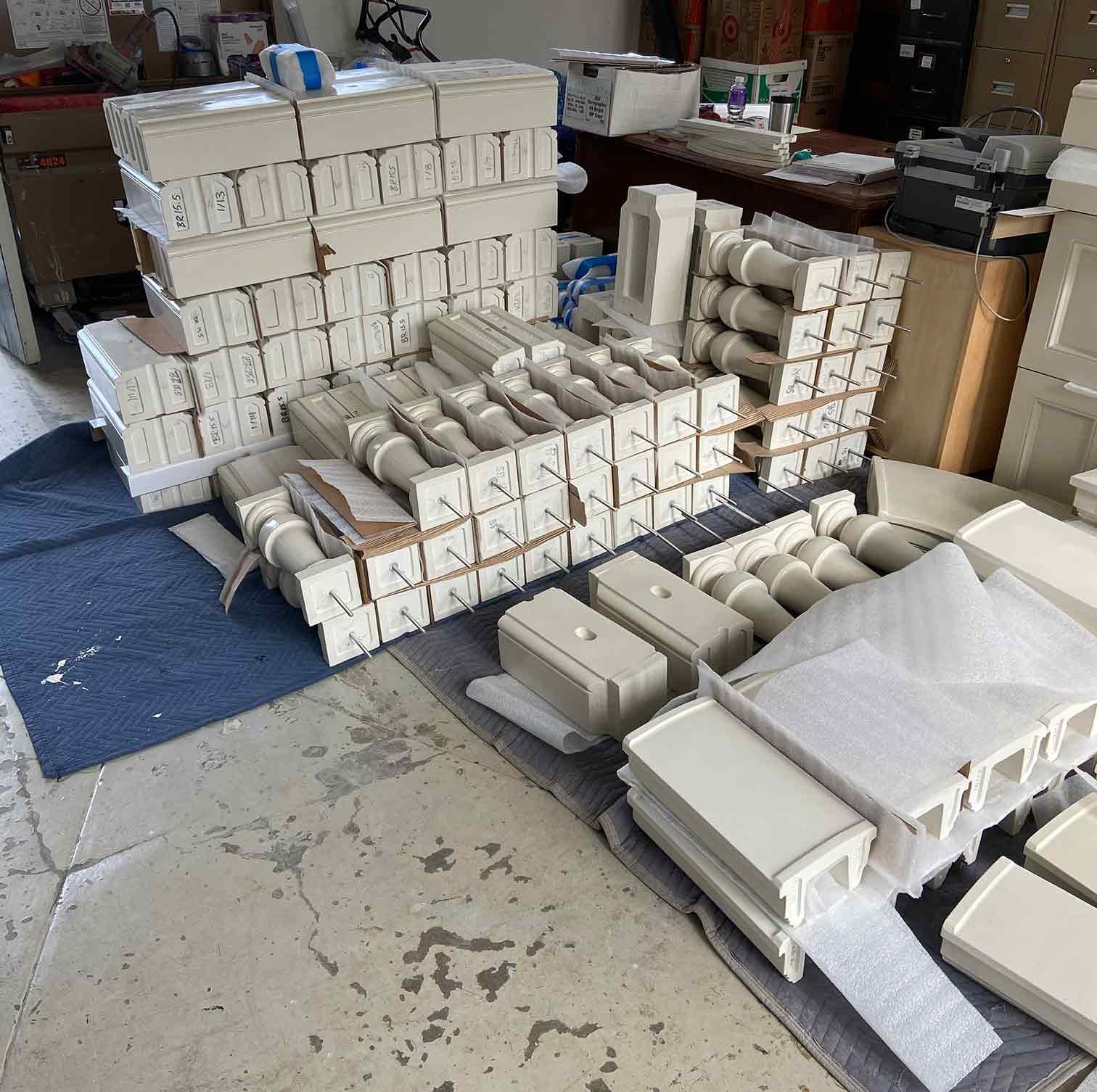 Individual balustrade components, bases, balusters, and rail caps, being prepared for delivery. GFRC with applied finish