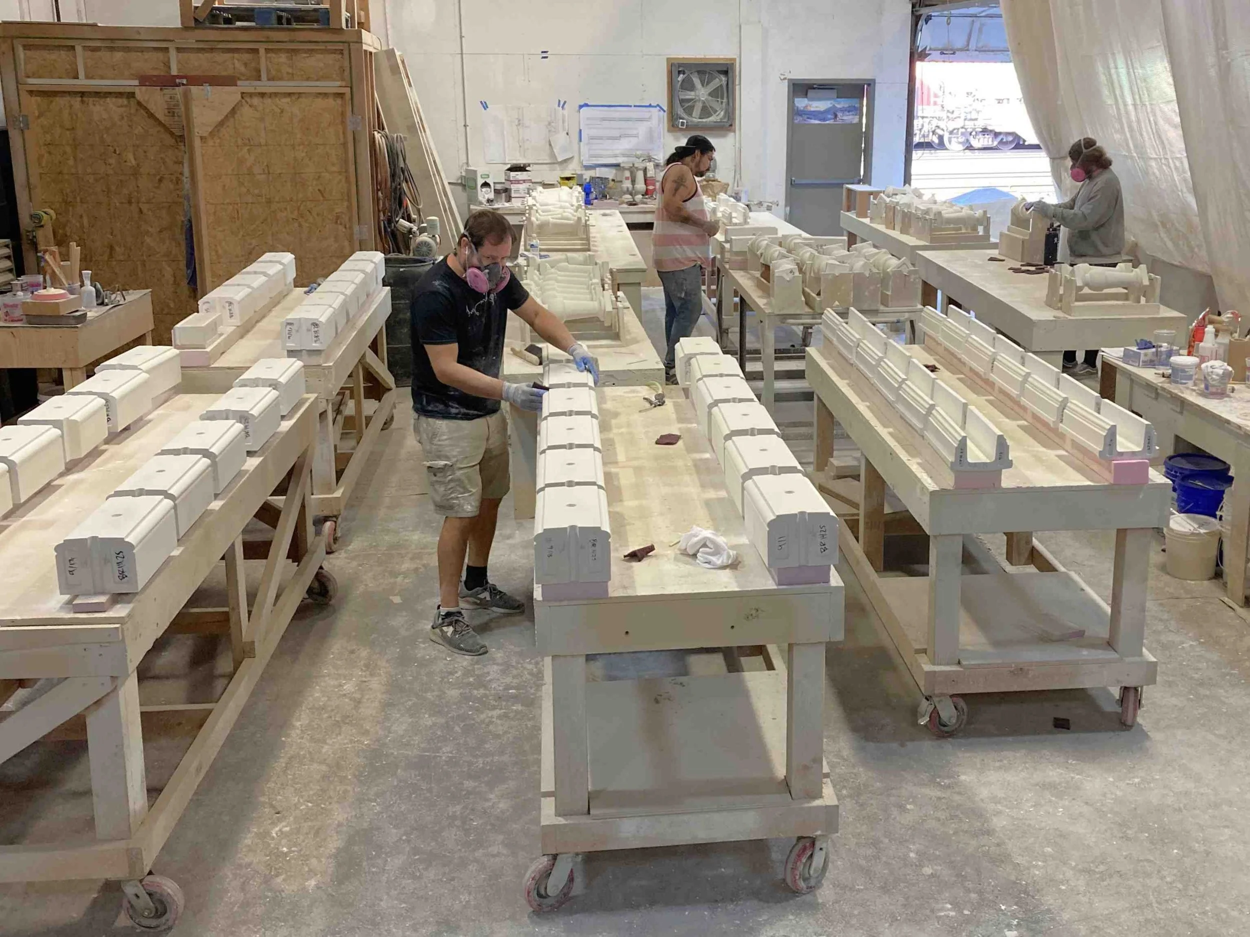 Prepping individual GFRC parts for final finish with aliphatic urethane, simulating glaze.