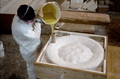 Pouring urethane rubber to mold new rosette sculpture, Furuya Bldg, Seattle, WA.