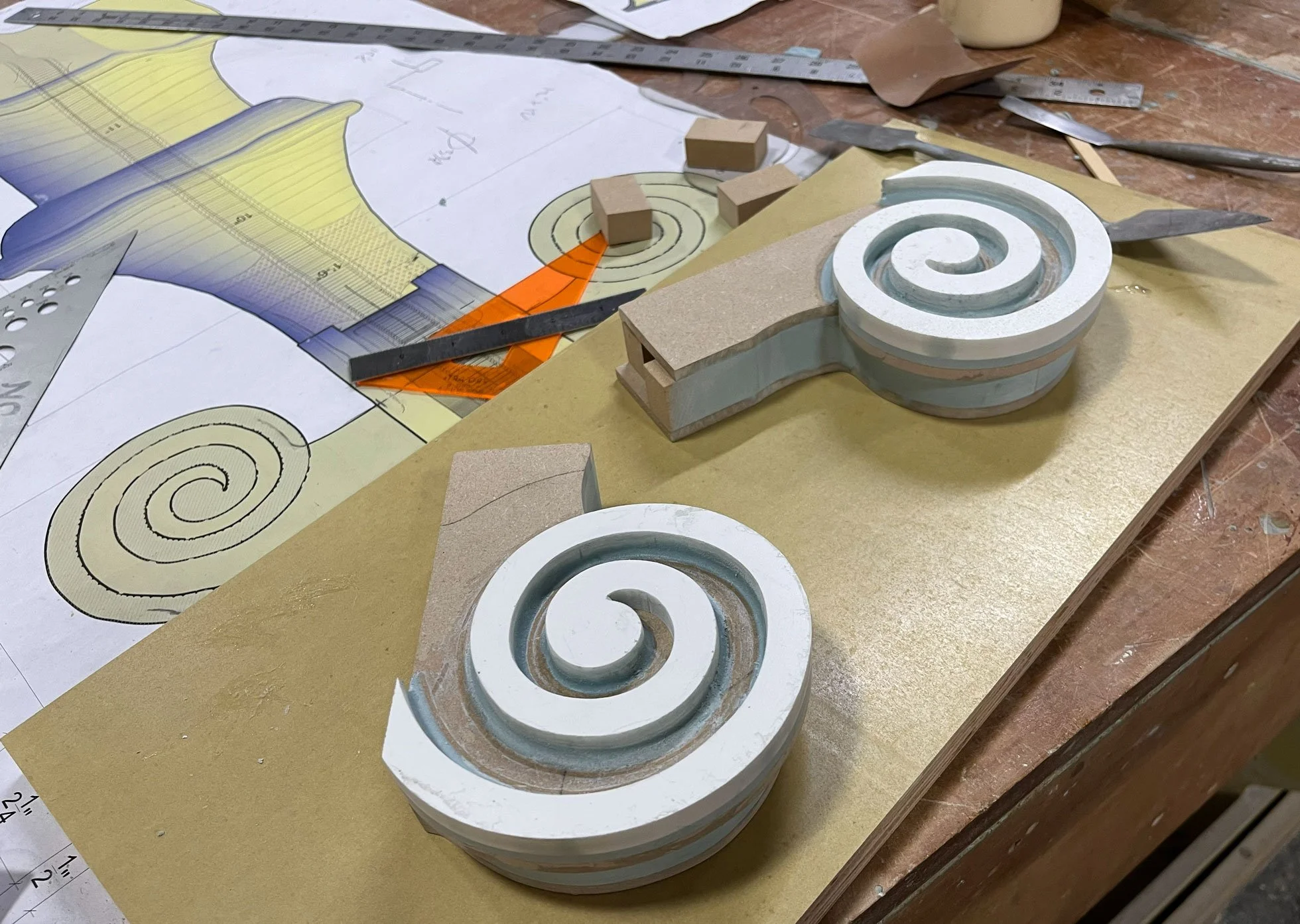 ACI Studios tooling workbench with plans and models of historic parts.