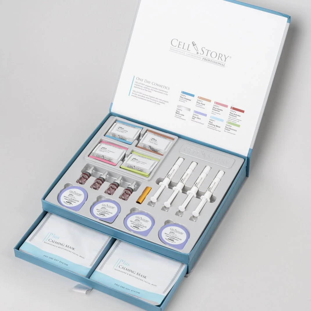 Open skincare treatment kit with various ampoules, syringes, and masks labeled 'Cell Story' and 'Plus Calming Mask' inside a light blue box.
