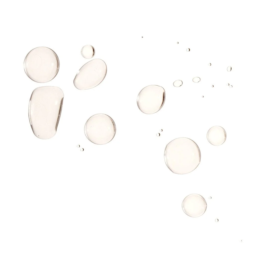 Various sizes of clear, round droplets or bubbles on a white background.