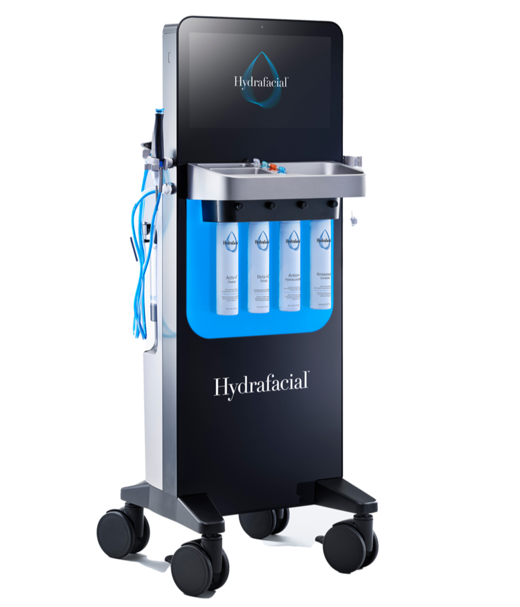 A HydraFacial machine with a digital screen, multiple bottles labeled with skincare product names, and a water sink, used for facial skincare treatments.