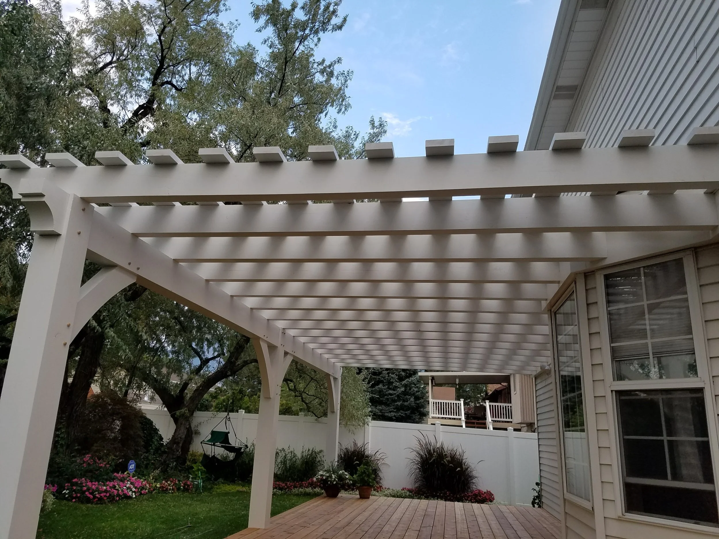 White backyard pergola and patio install for a custom timber design. 
