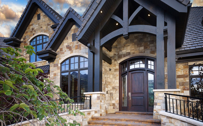 Front entrance of a house with custom outdoor timber beams to elevate the design. 
