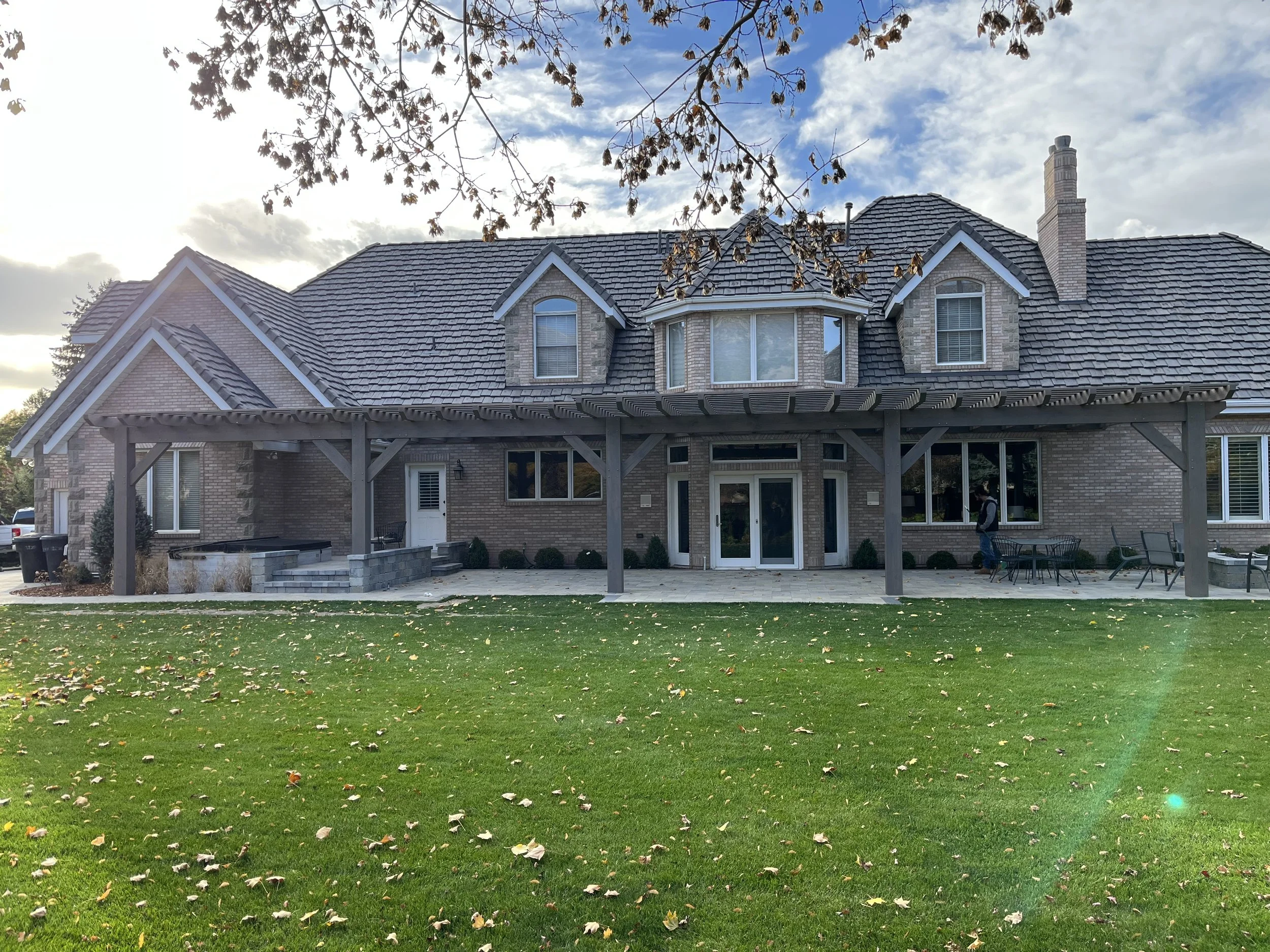 Modern backyard pergola install shading the patio. 