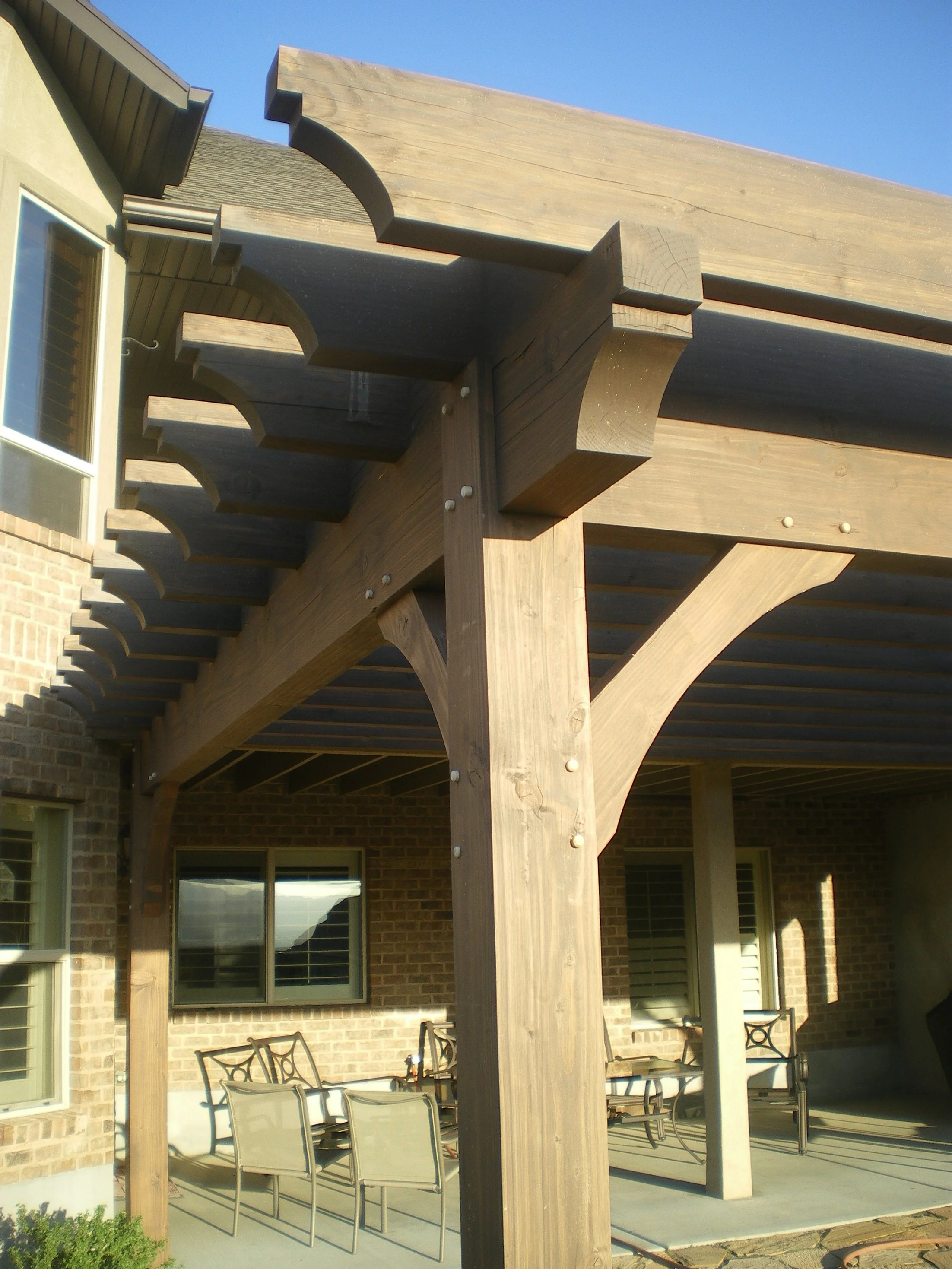  A rustic modern pergola build over the backyard patio.