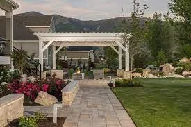 White pergola install over patio with backyard fire pit. 