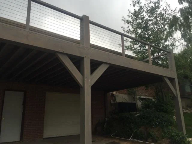 Our timber deck with metal railing supported by large timber posts over the garage and yard.