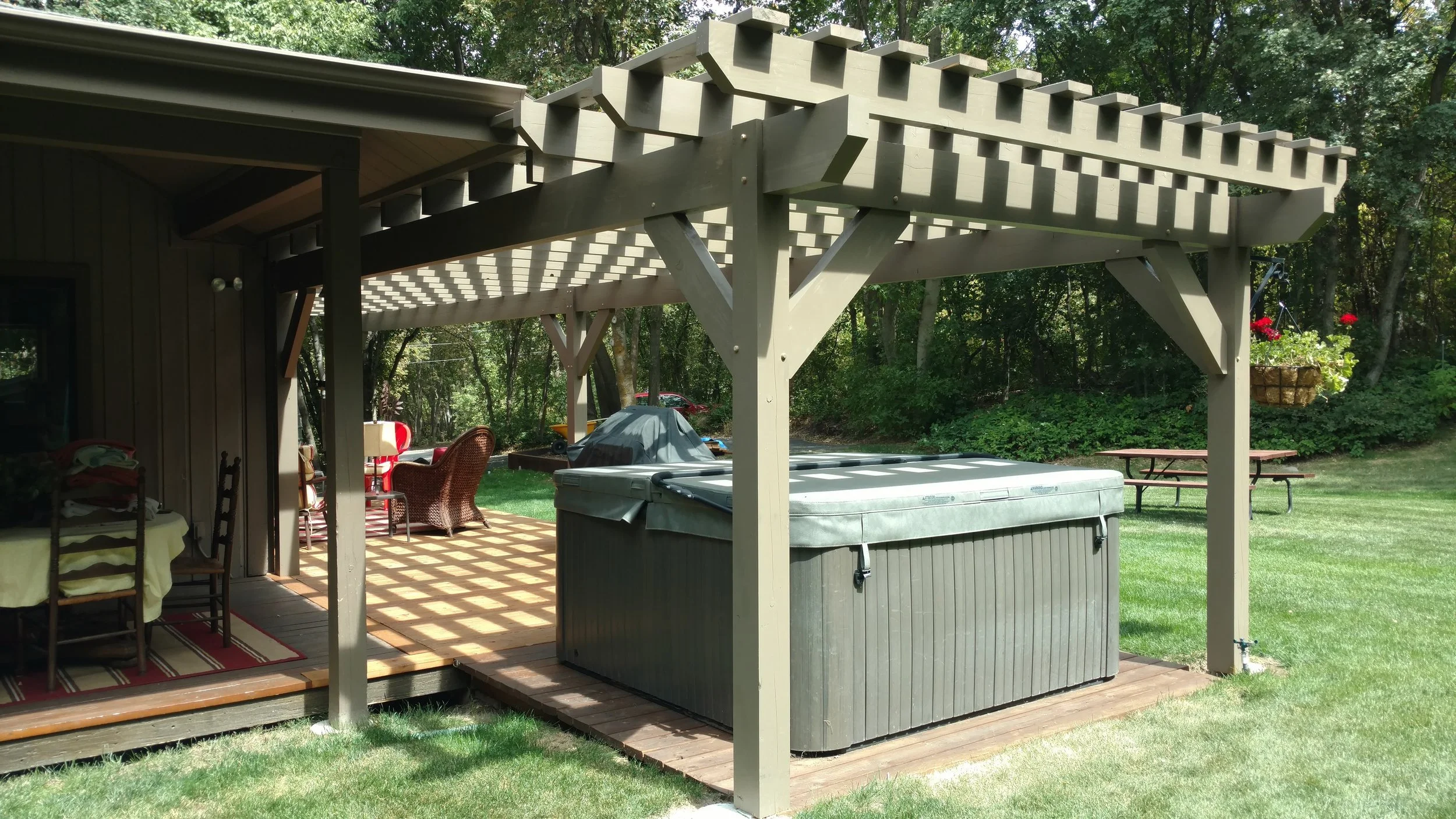 Custom layered timber pergola designed to elevate backyard outdoor living.