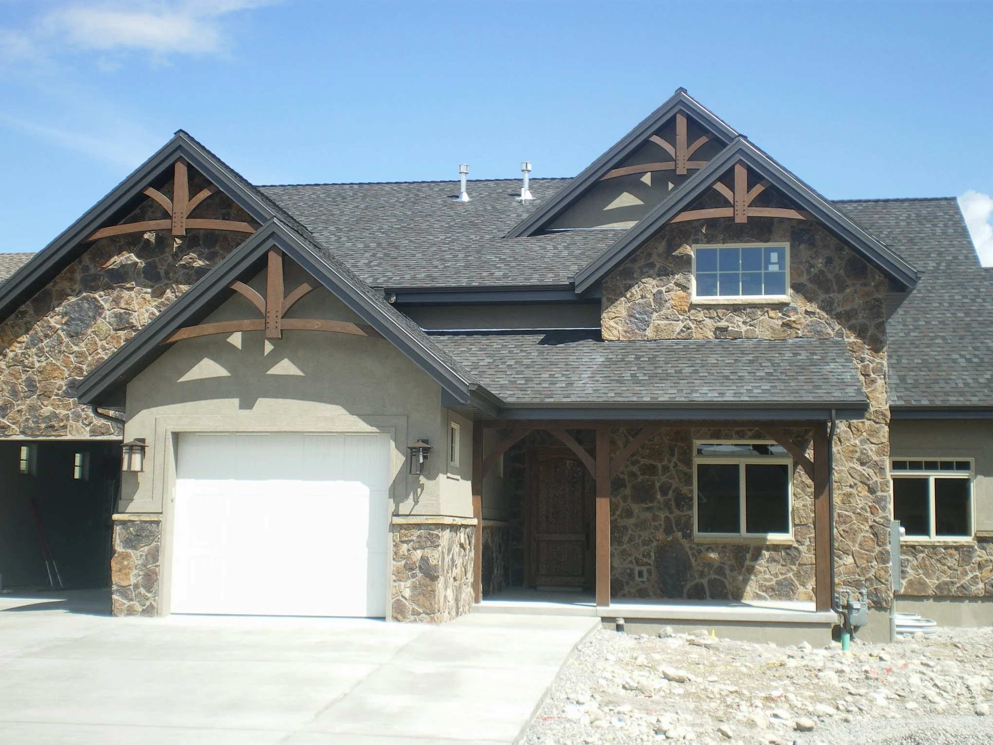 A new home being built, showcasing our front outdoor heavy timber beams, to add depth to their home. 