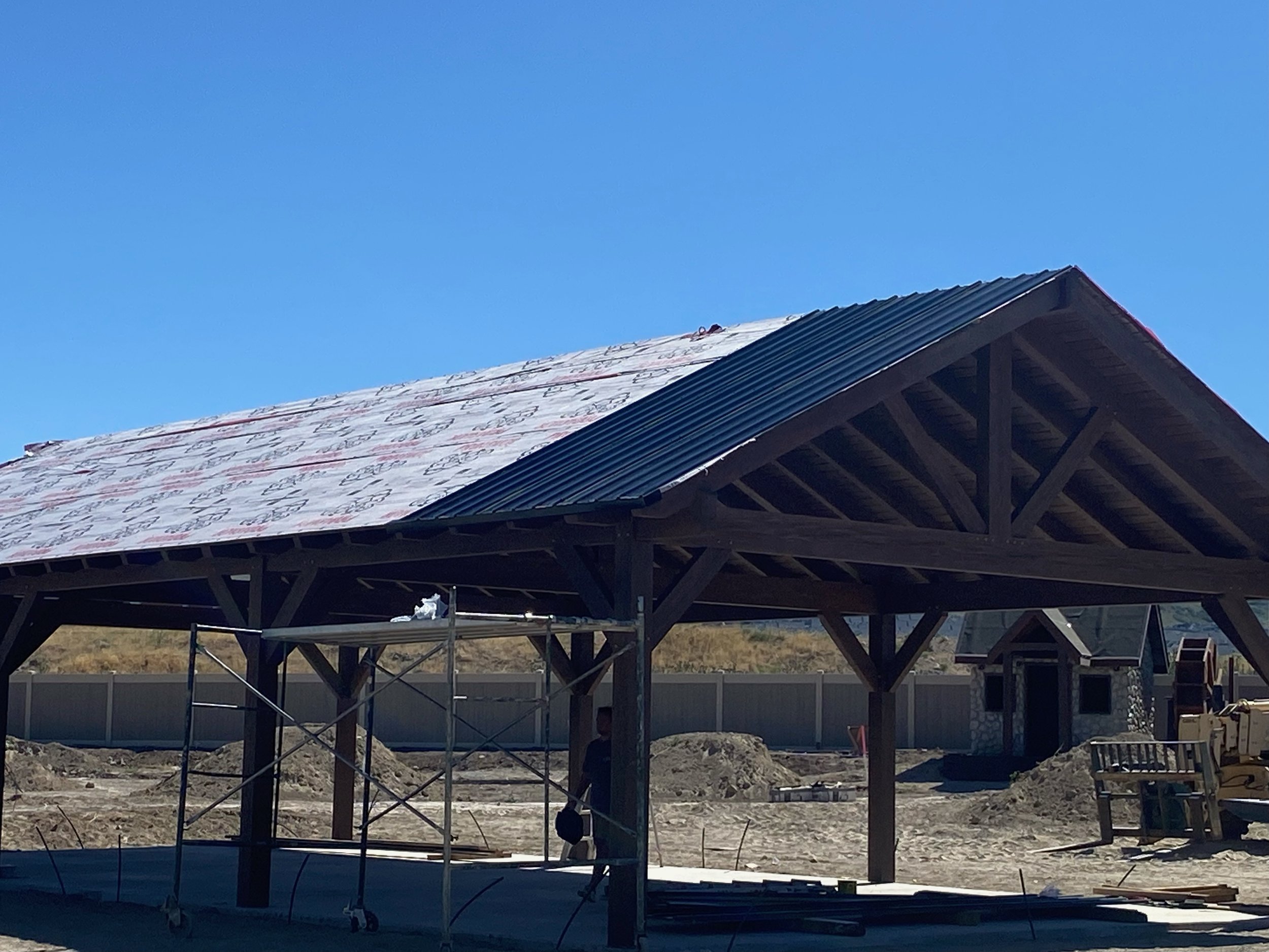 A timber pavilion being installed while onsite. 