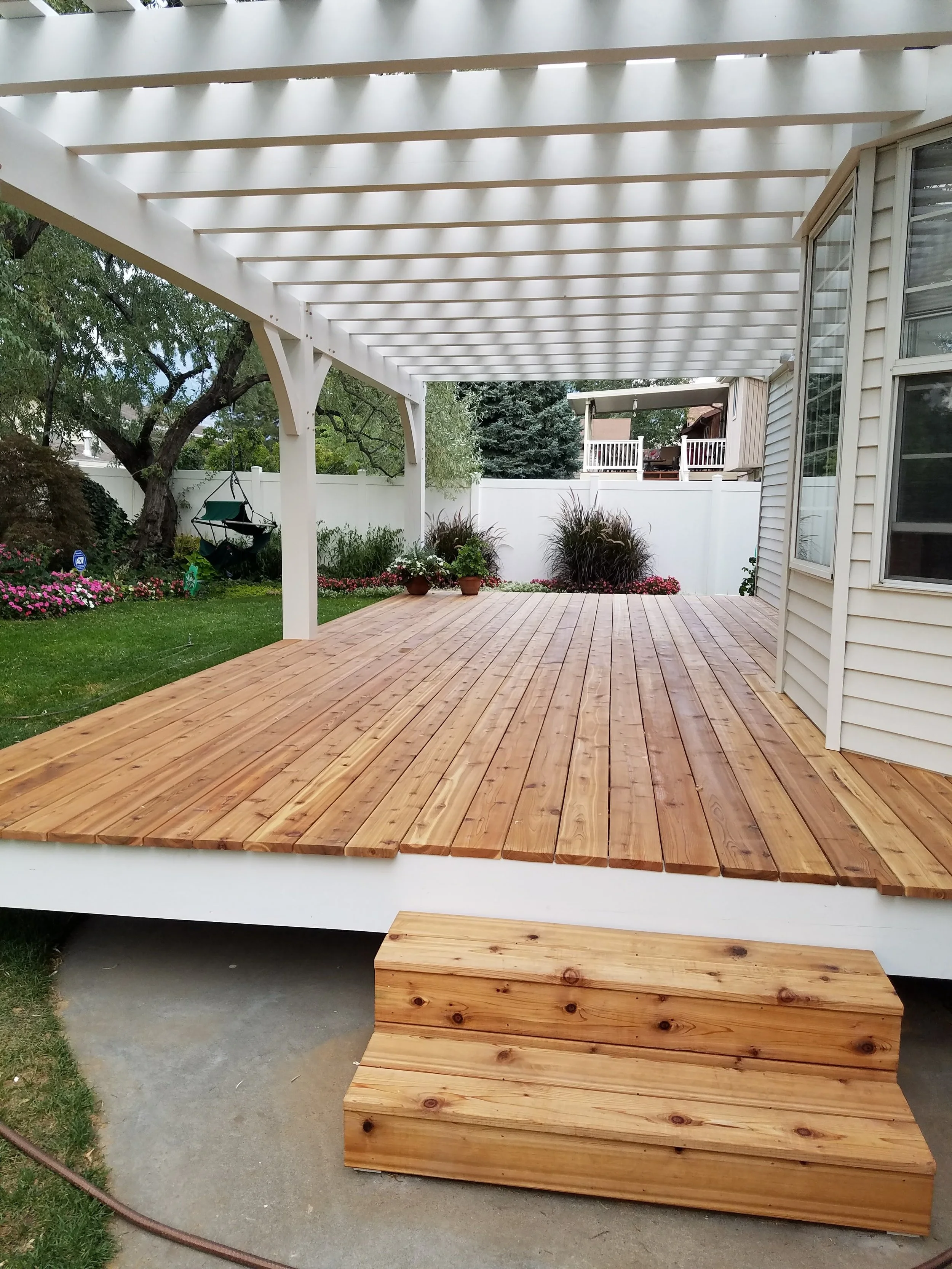  White backyard pergola and patio install for a custom timber design. 