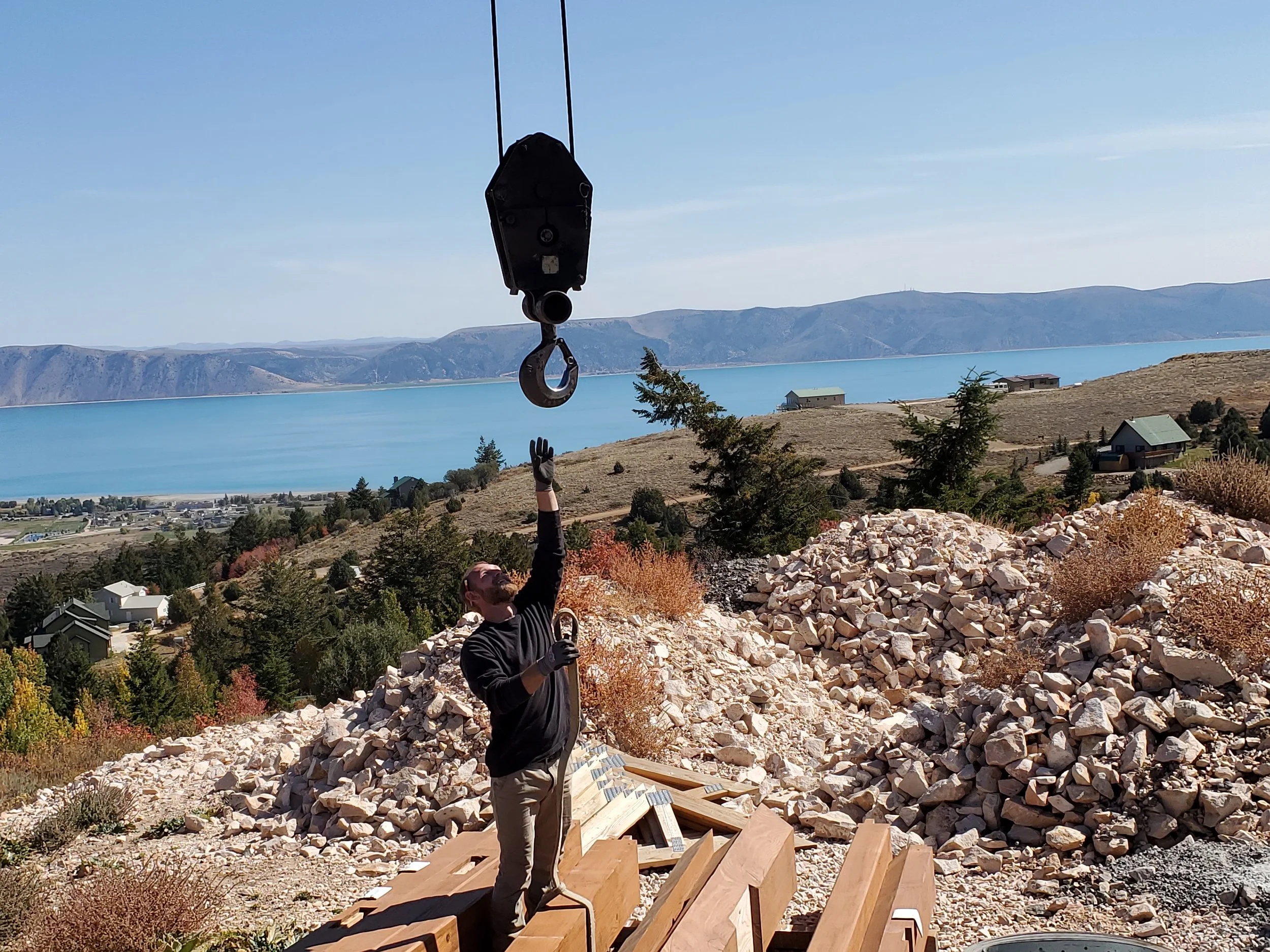Our team member on a construction site lifting each timber frame to a crane for the install. 
