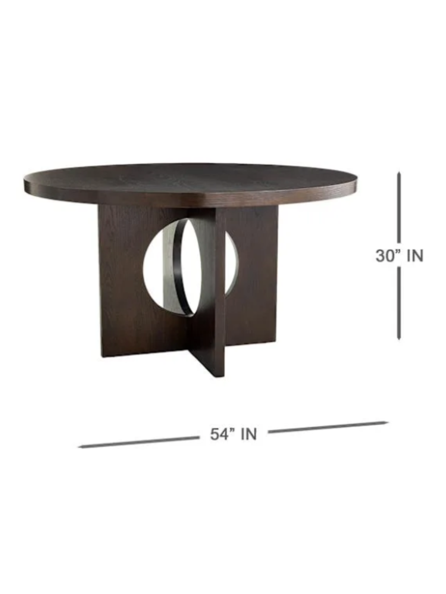 Modern round dining table in dark walnut wood finish, featuring a thick circular tabletop and sculptural intersecting pedestal base with circular cutout details. Dimensions.
