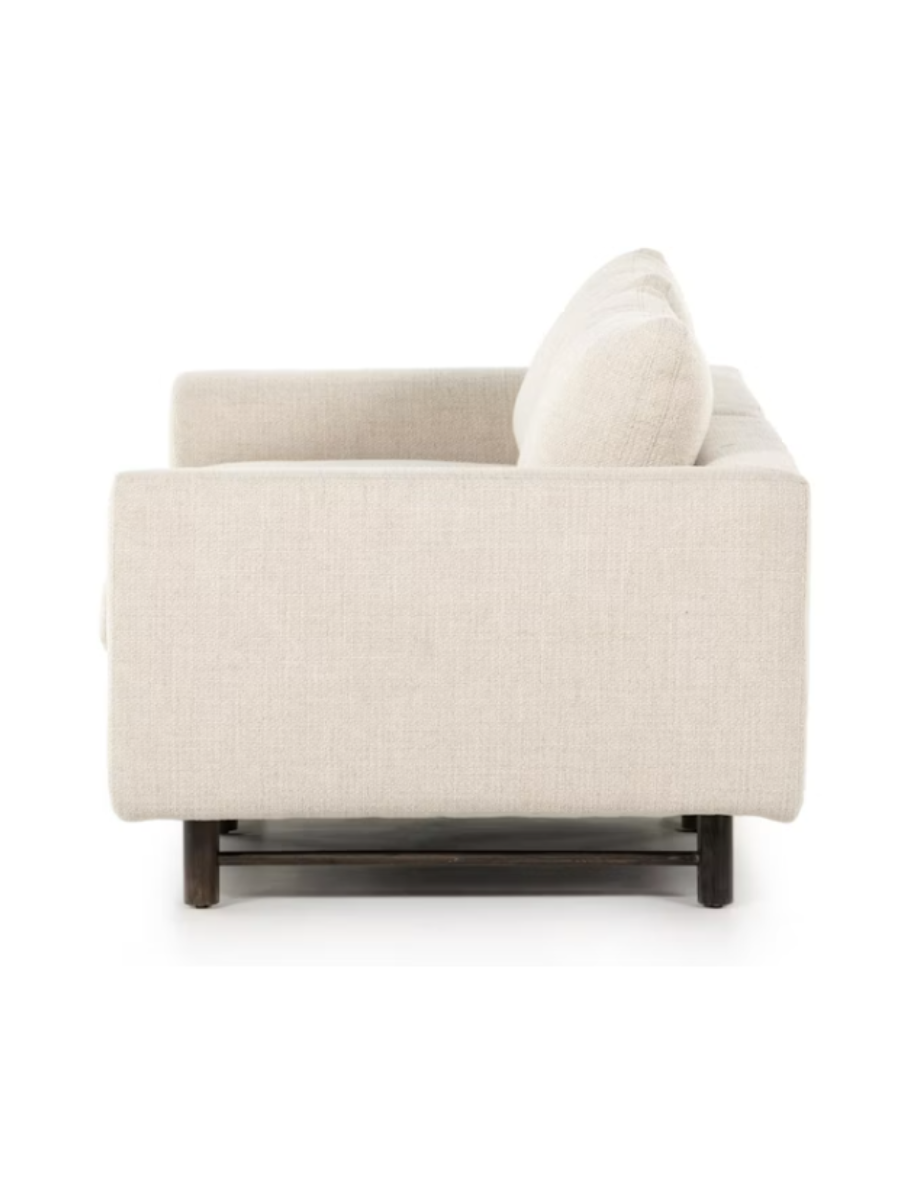 Modern two-piece sectional sofa upholstered in ivory textured fabric, featuring plush seat and back cushions, gently rounded arms, and short dark wood legs.