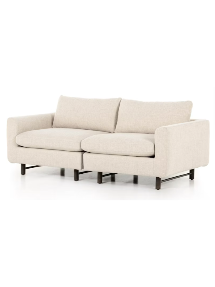 Modern two-piece sectional sofa upholstered in ivory textured fabric, featuring plush seat and back cushions, gently rounded arms, and short dark wood legs.