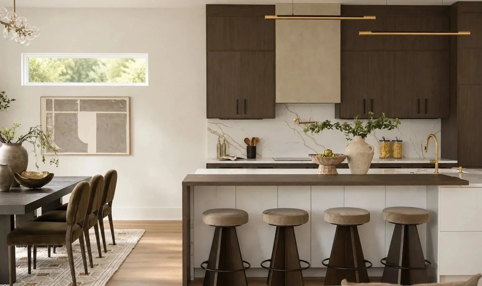 Modern kitchen and dining area with natural wood cabinets, marble backsplash, and gold fixtures; dining table with upholstered chairs, kitchen island with bar stools, decorative plants, and artwork on the wall.