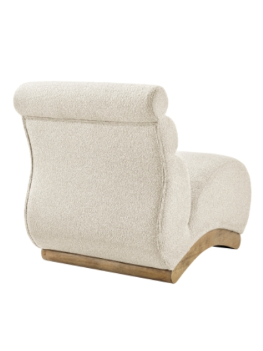 Modern armless accent chair upholstered in cream bouclé fabric, featuring a sculptural curved seat, channel-tufted backrest, and natural wood base.