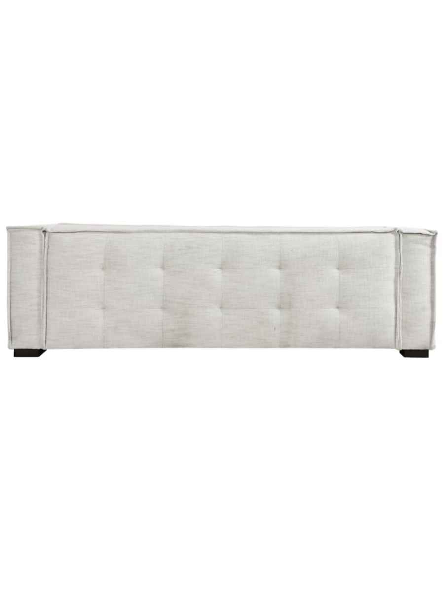 Modern ivory textured fabric sofa featuring subtle tufting along the backrest and bench seat, wide square arms, clean piping details, and short dark wood legs.