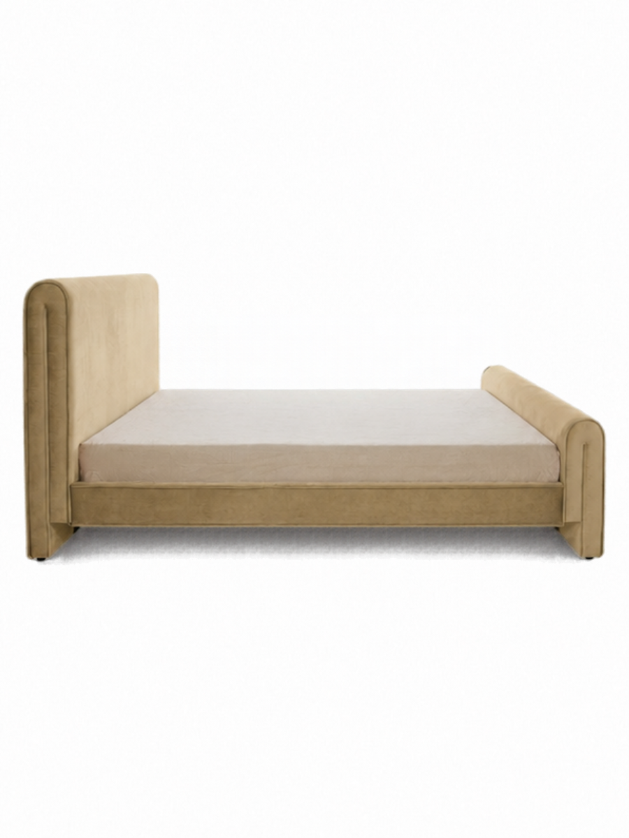 Carmel colored velvet bed with a headboard and footboard. Side view.