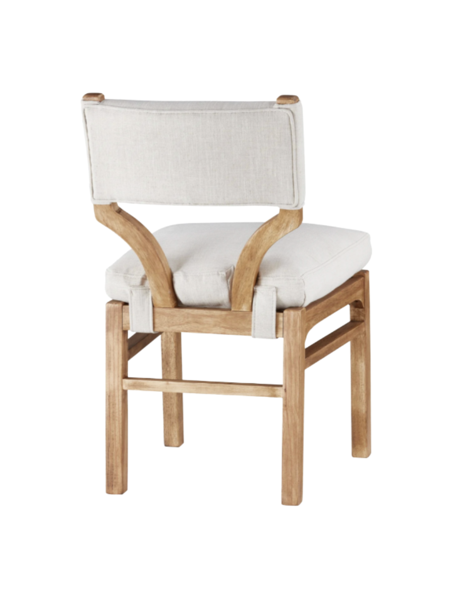 dining chair with wood frame + legs and cream upholstered back and seat with strap detail wrapping underneath seat.