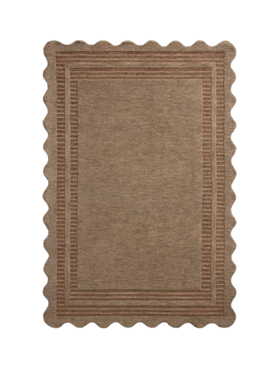 Hand-tufted wool area rug with a playful scalloped edge and lower-pile, striped border for a touch of structure. With mocha brown and rust/clay colors along the fun border. (7’9”x 9’9”)