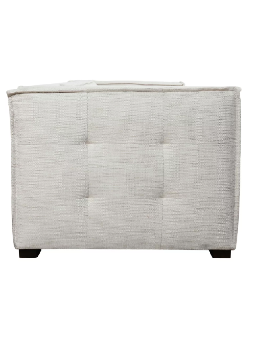 Modern ivory textured fabric sofa featuring subtle tufting along the backrest and bench seat, wide square arms, clean piping details, and short dark wood legs.