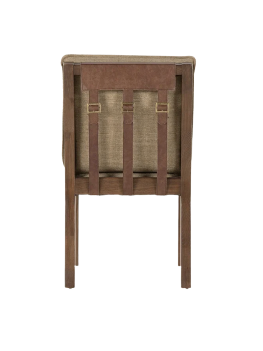 Wood dining chair with upholstered seat and back, with leather buckle details on back of chair.
