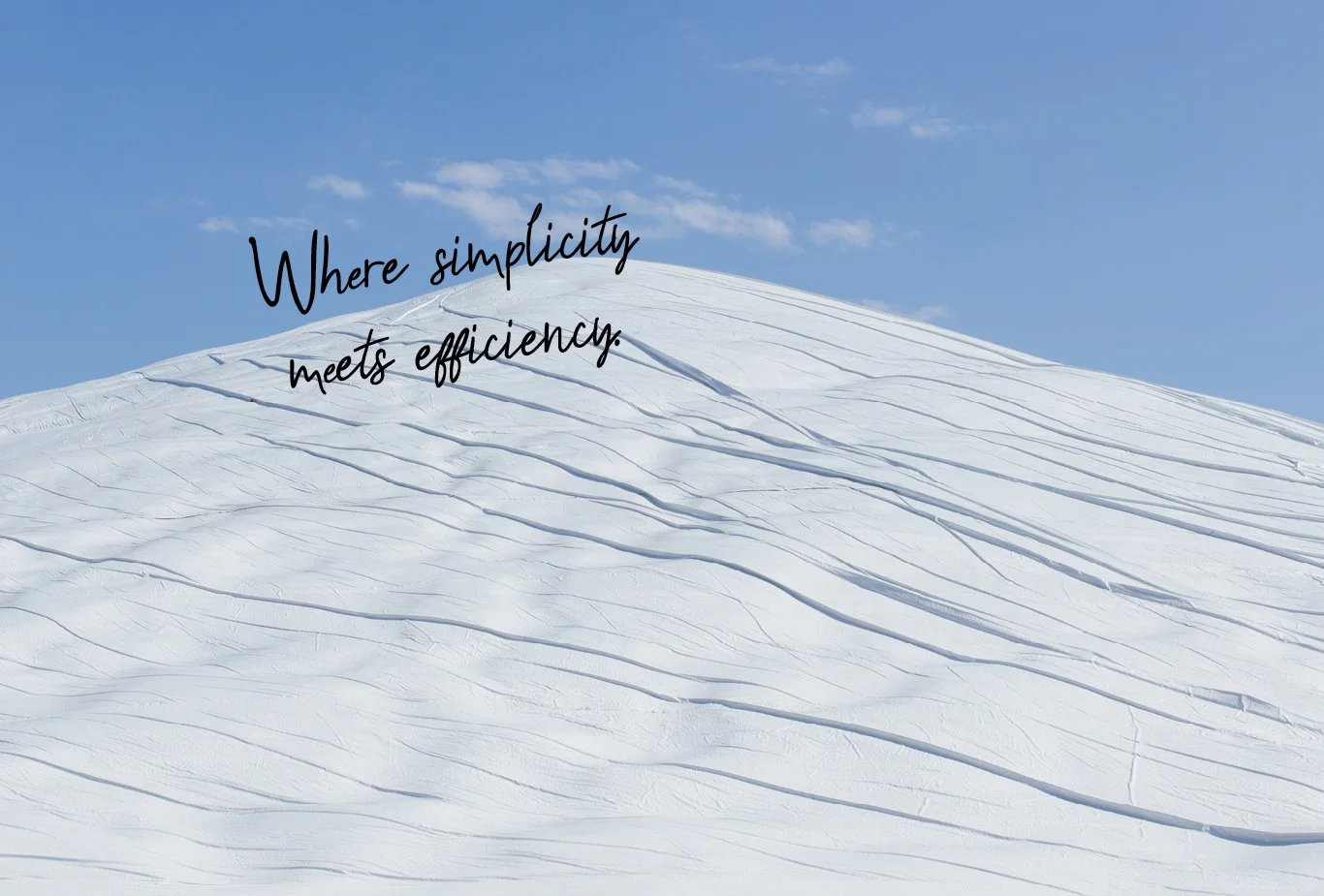 A snow-covered mountain slope under a blue sky with some scattered clouds, featuring the quote 'Where simplicity meets efficiency' in black cursive font.