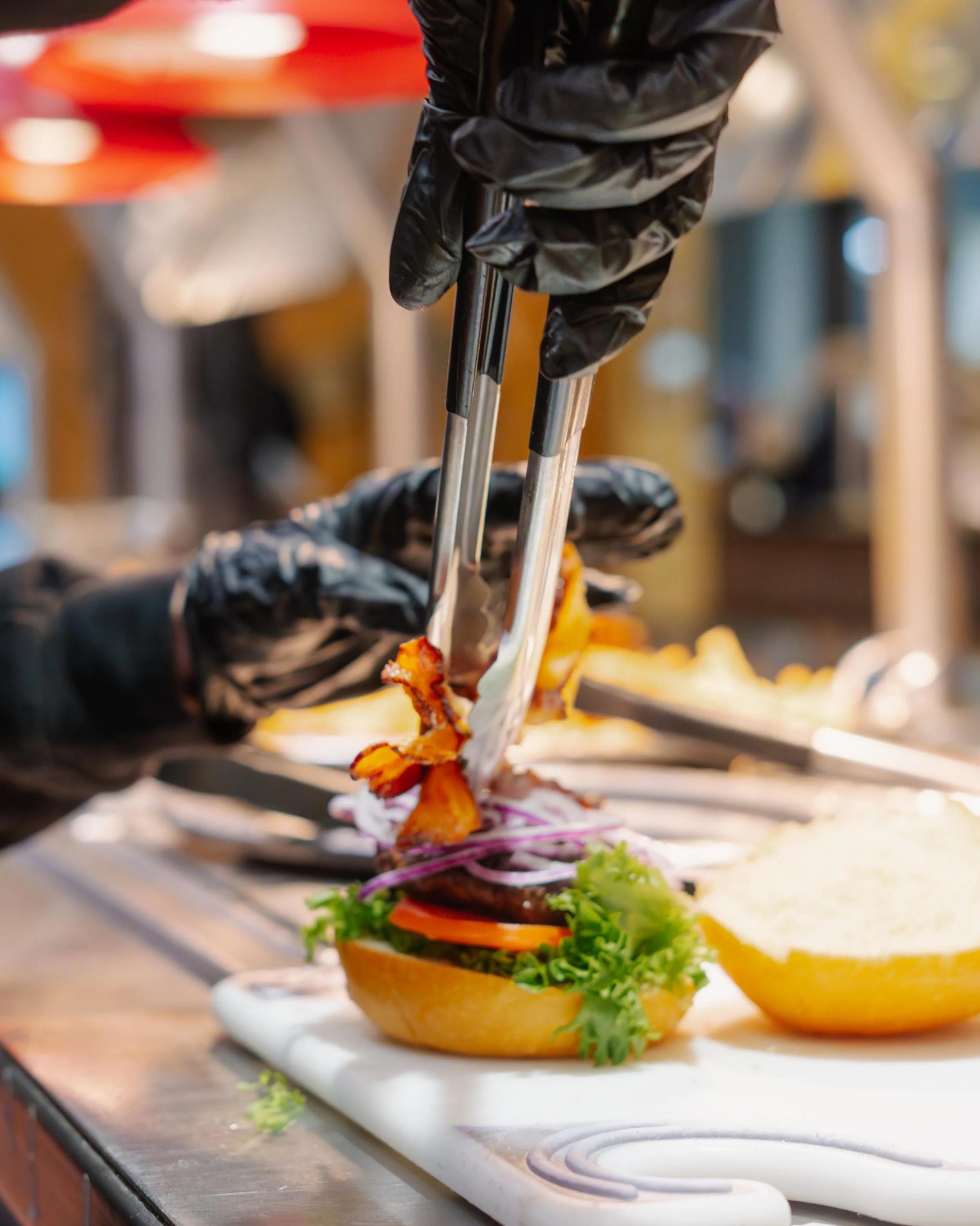 Ghost Kitchen Employee Assembling A Hamburger