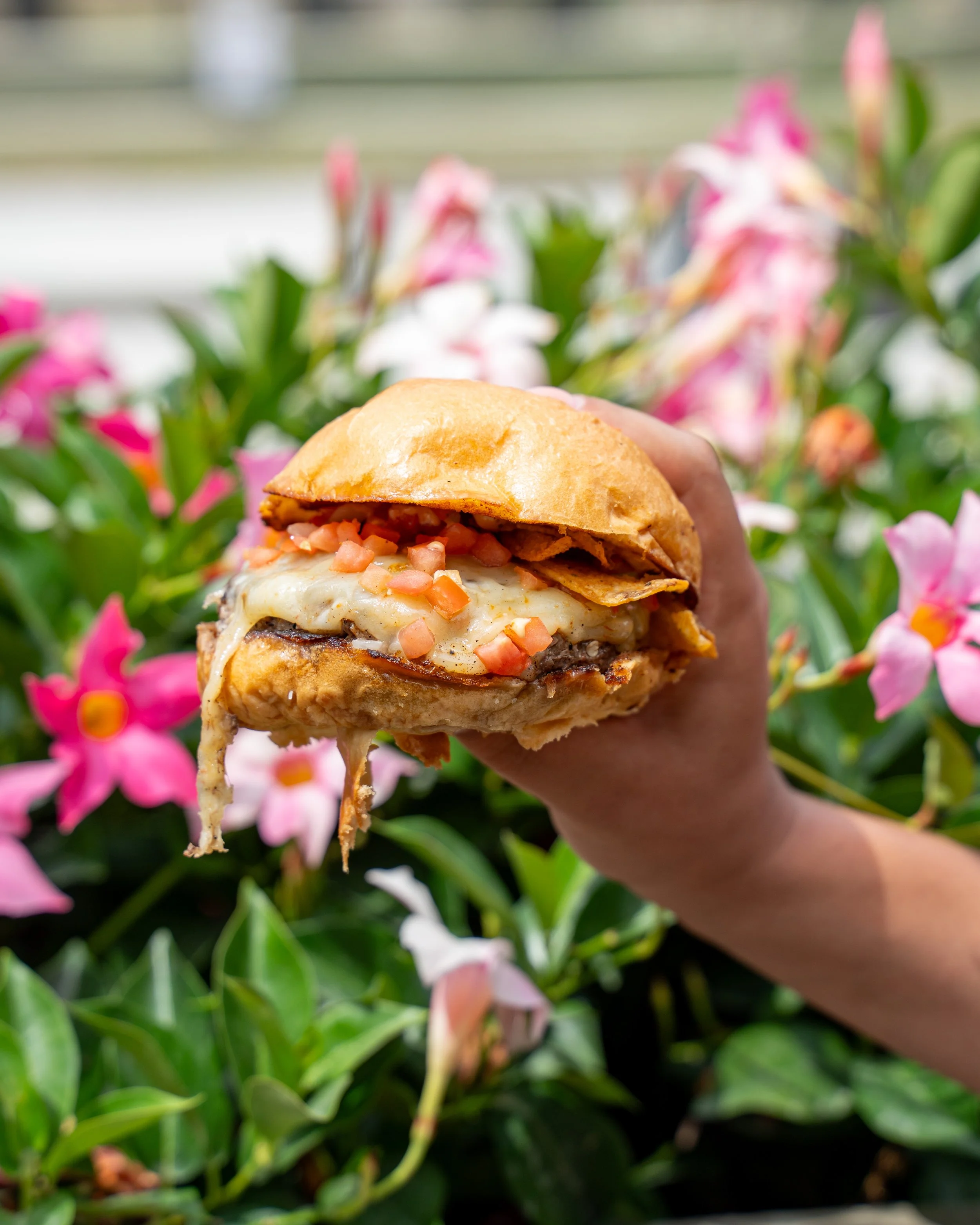 Rollin Ghost Burger With Cheese In Front of Flower Bed