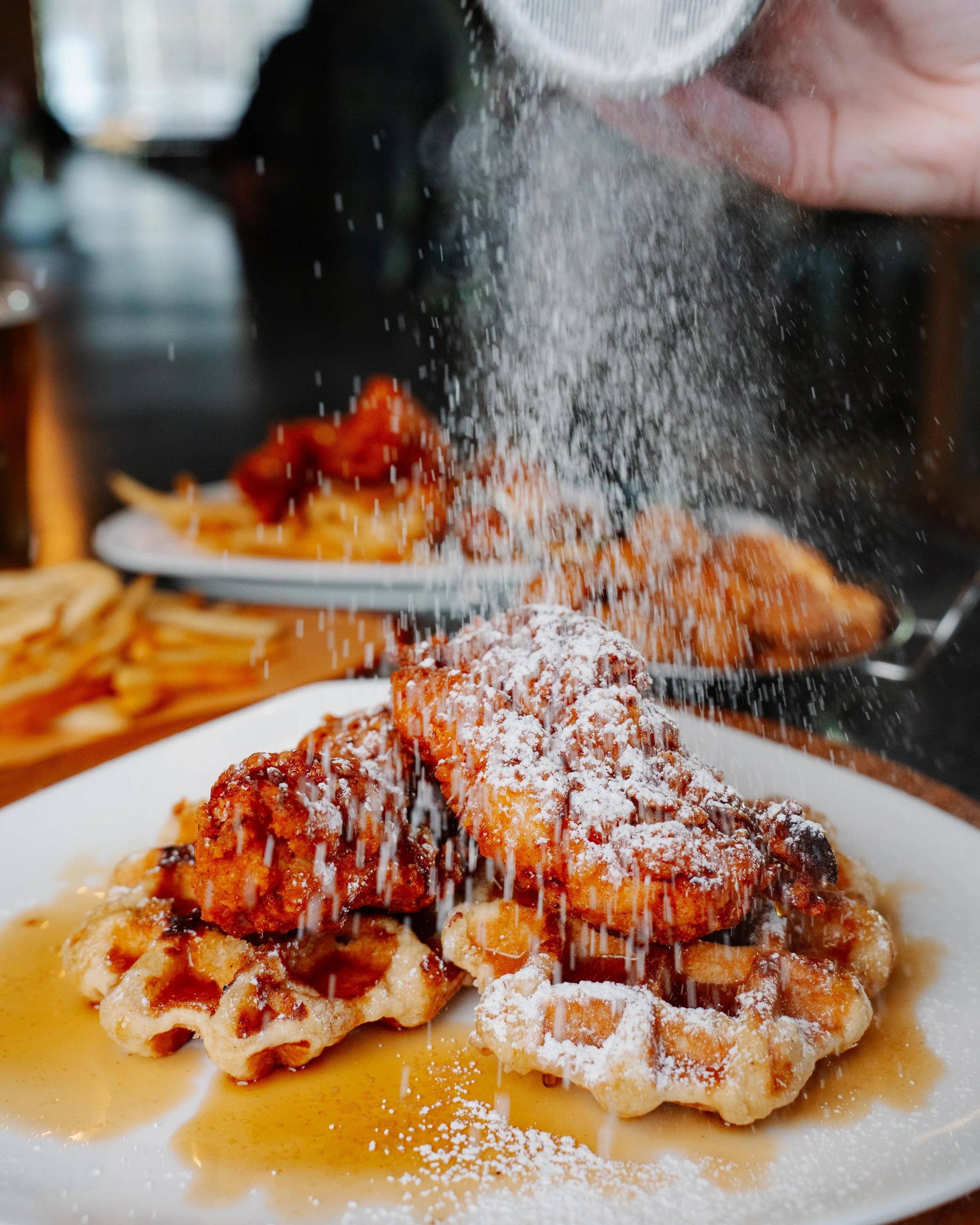 Rollin Ghost Chicken and Waffles with powdered sugar sprinkled on top