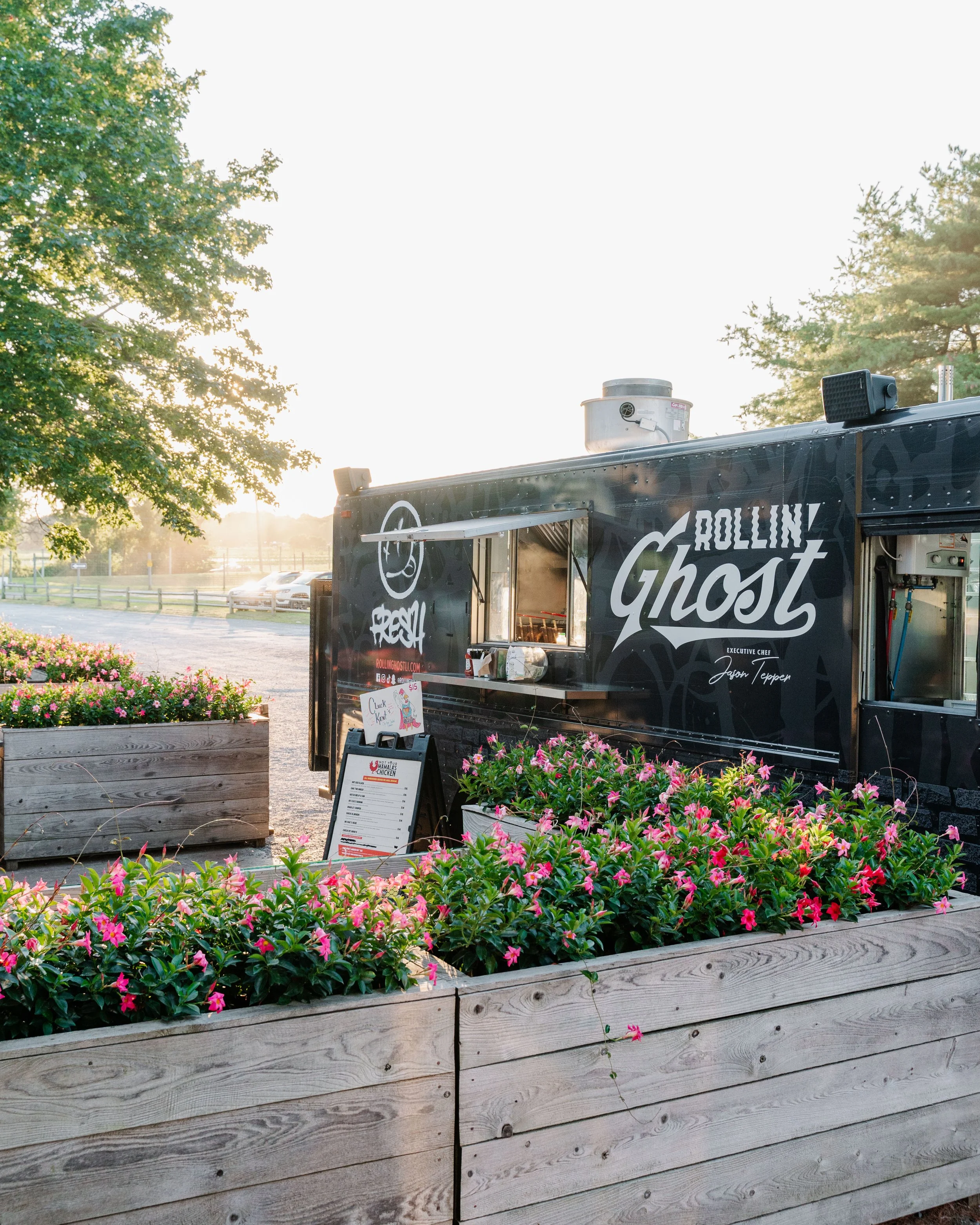 Side View of Food Truck With Sunset and Flowers